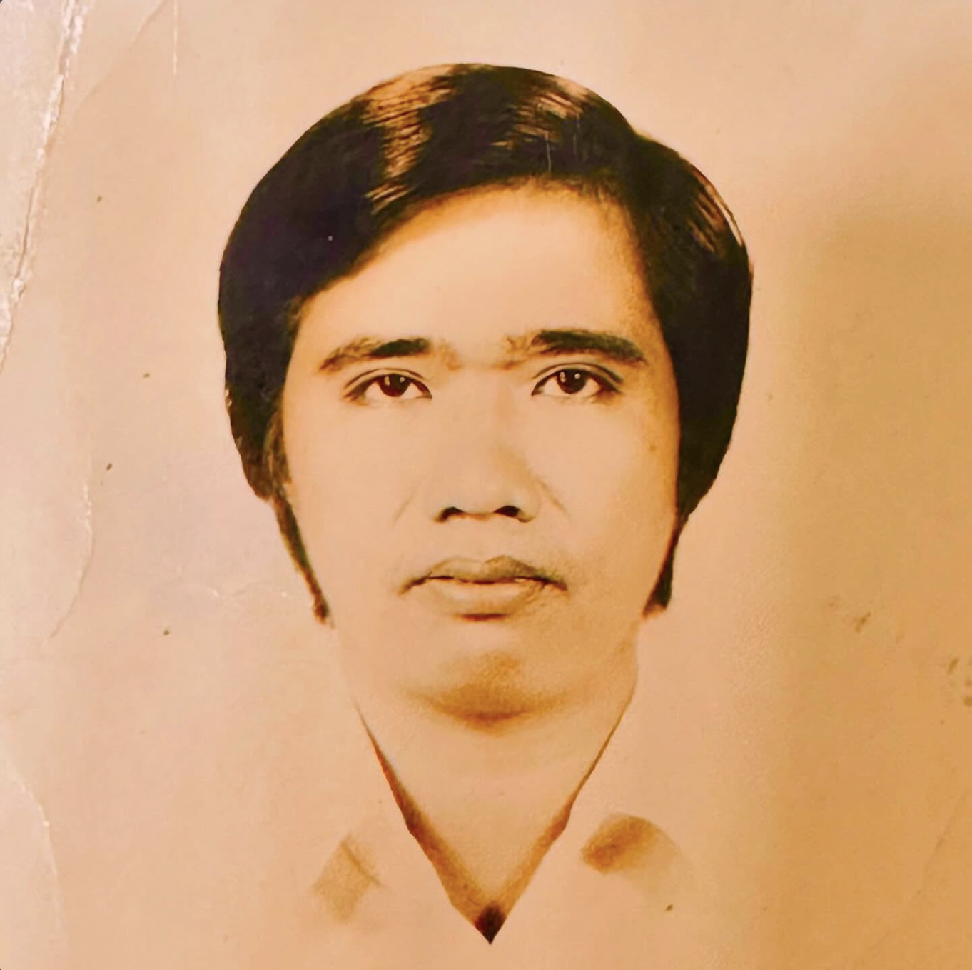 A vintage portrait of Freshly, the inspiration behind the product. He has short dark hair, wearing a light-colored top, against a peach background.