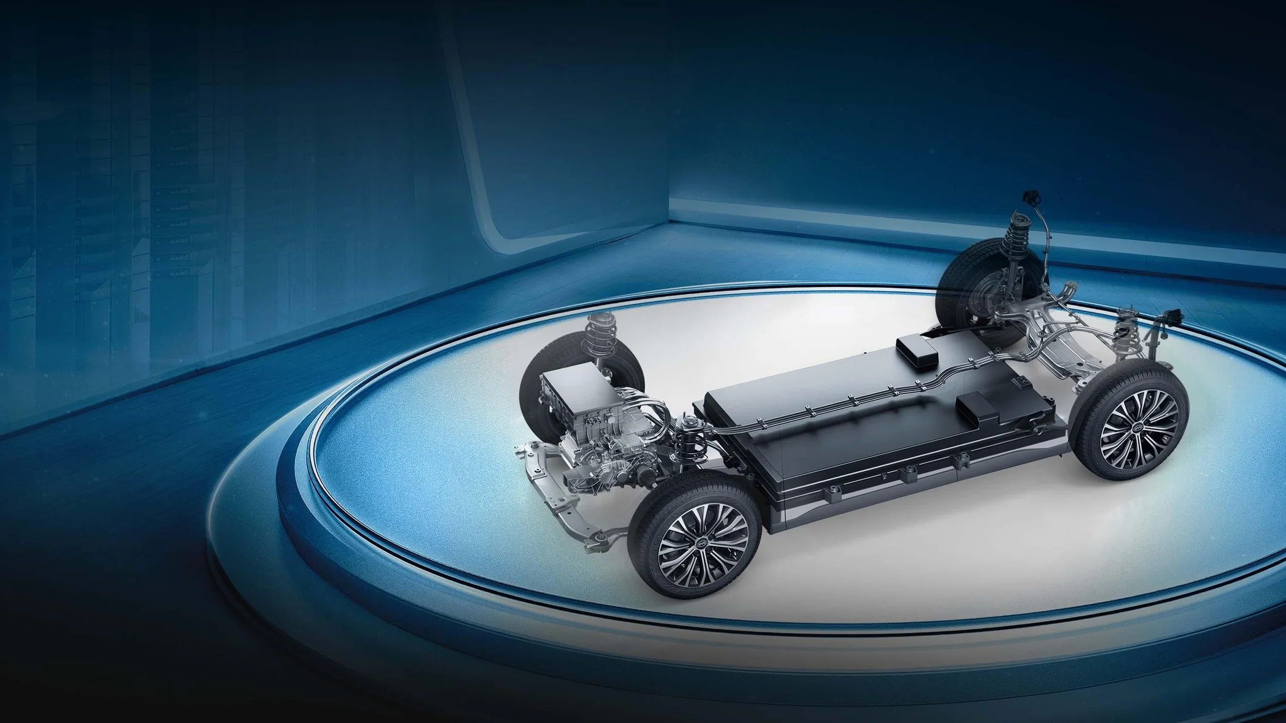 Interior view of an electric vehicle showing its chassis, battery pack, and electric motor, with a futuristic blue background.