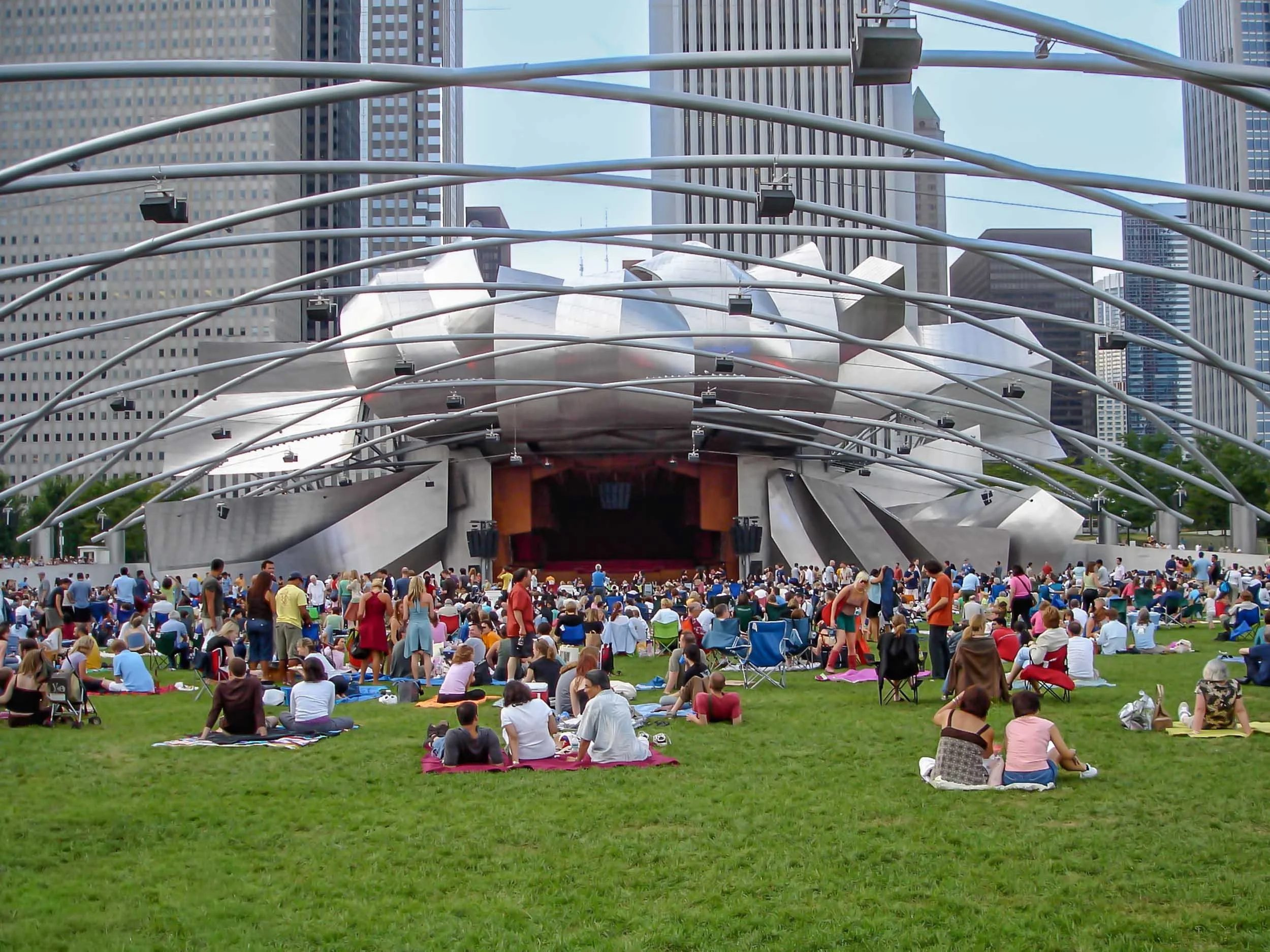 The Jay Pritzker Pavilion is the centerpiece of Millennium Park, featuring a 52,000-square-foot stage, 4,000 fixed seats, and a massive 95,000-square-foot lawn that accommodates an additional 7,000 people. It is renowned for its state-of-the-art soun