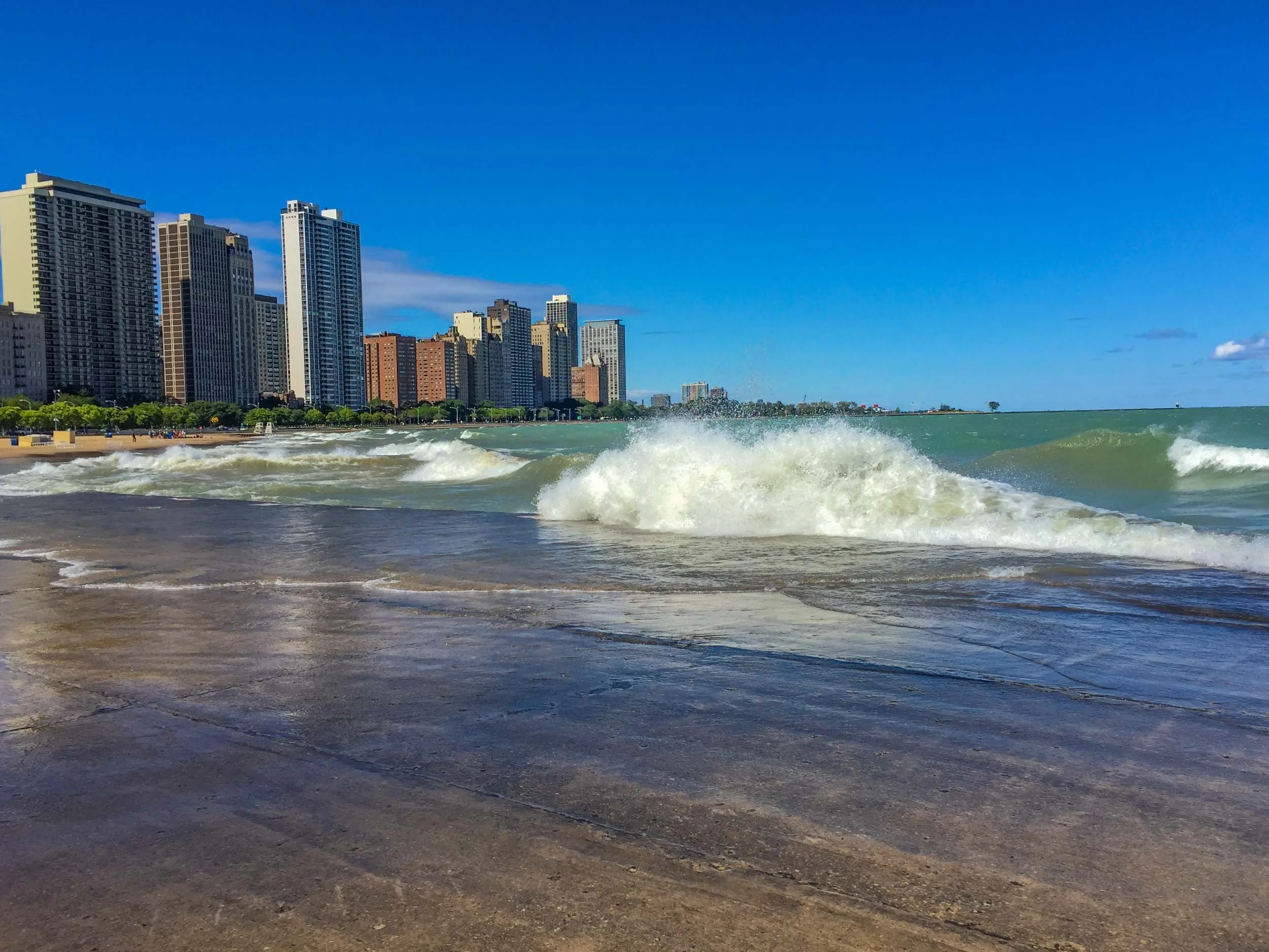 When the "Windy City" provides the wind the lakefront is anything but placid. In this pic the waves are breaking over the seawall. Years before on a business trip Lake Shore Drive was closed because lake waters rose so high and froze solid on the roa