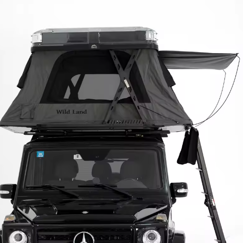 Black Mercedes-Benz off-road vehicle with a rooftop tent and a side awning extended.