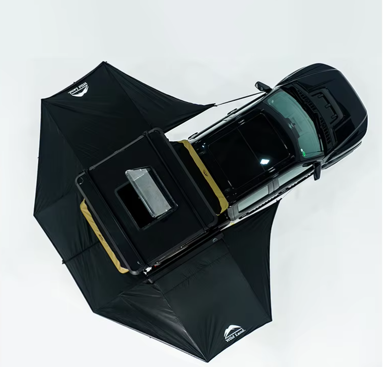 Camera setup with a black pickup truck under two large black umbrellas for lighting