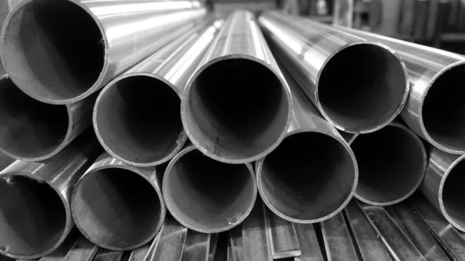 Stack of metal pipes in a warehouse or industrial setting.