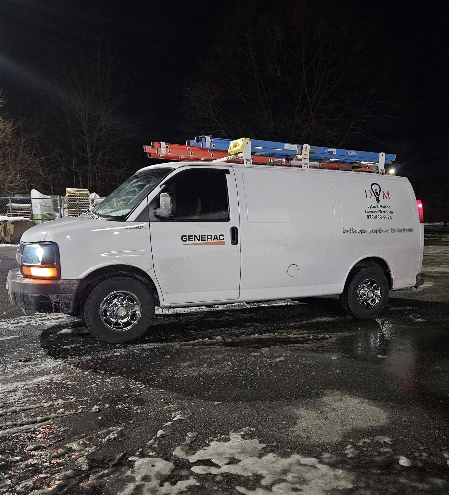 A white service van parked on a wet, snowy ground at night. The van has a ladder rack on top with colored ladders and a company logo reading 'DYM Dylan T Malone Licensed Electrician 978-888-5974'. The side also lists services like lighting, generators, renovations, and service calls.
