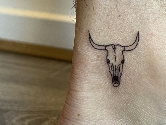 bull head skull fine line tattoo on inner ankle by banksia and blade