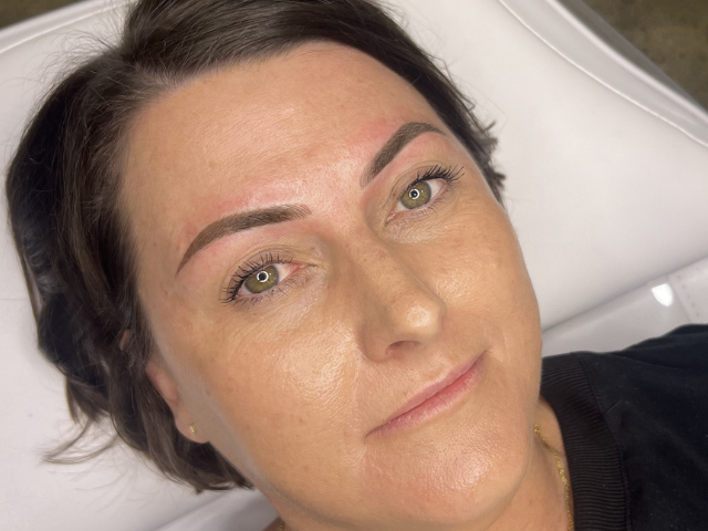 Close up client after cosmetic brow tattoo procedure by banksia and blade