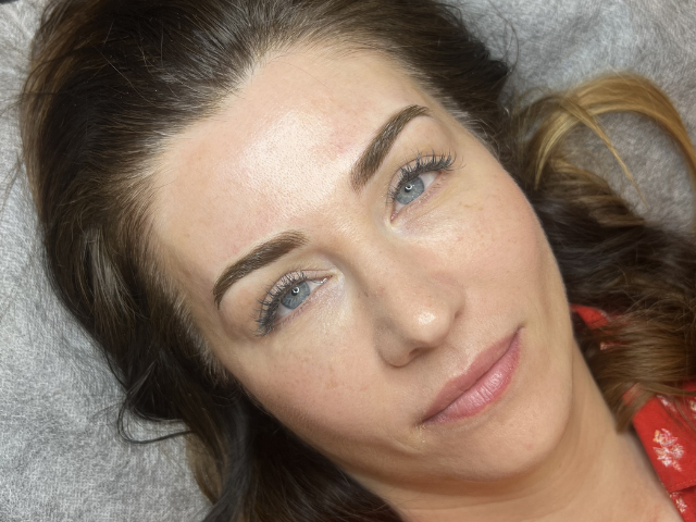 Close up lady looking at camera after cosmetic brow tattoo by Banksia and Blade