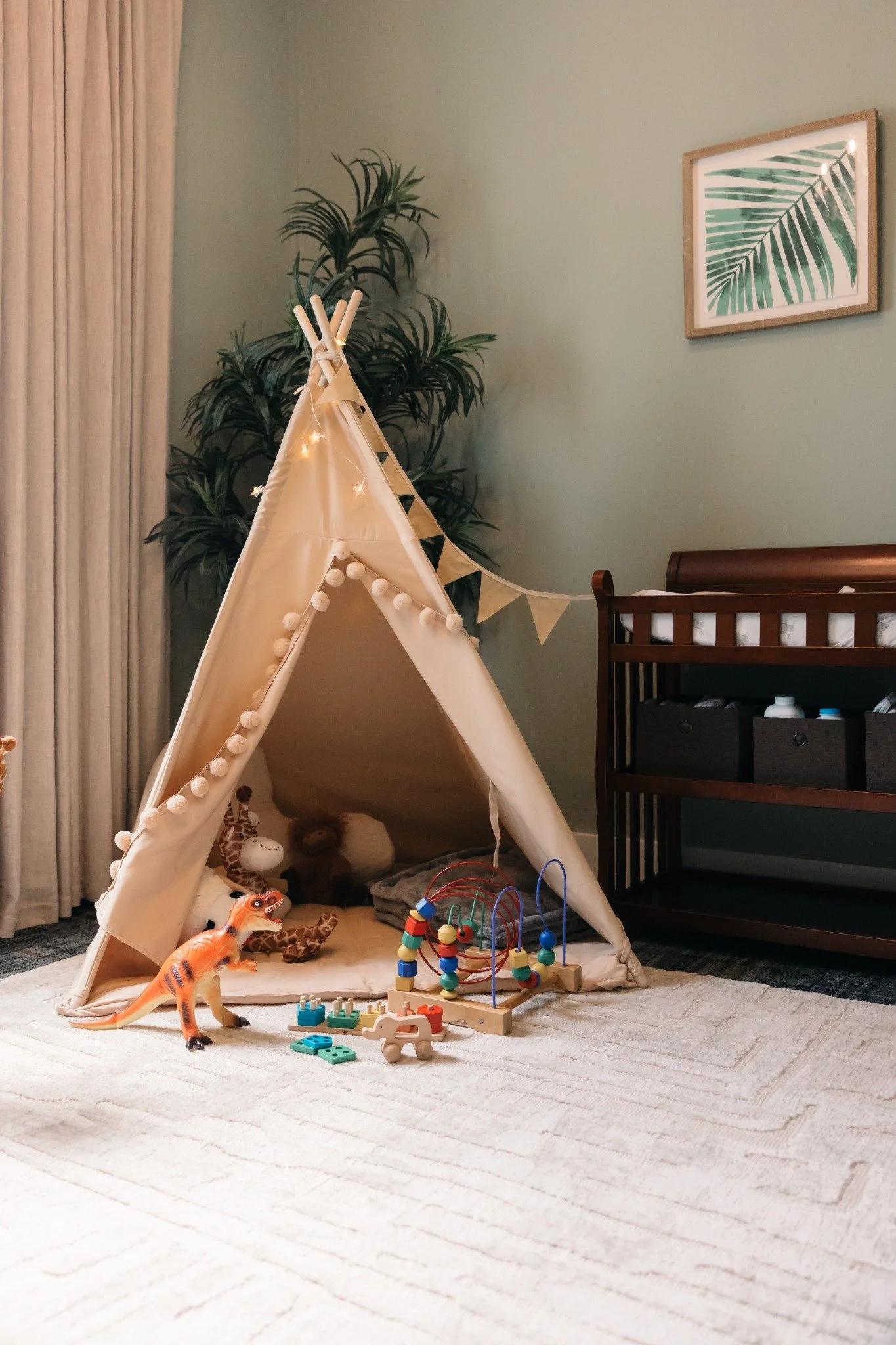 Ramble Creek nursery with teepee, dinosaur toy, wooden activity toys, and soft play area for kid-friendly weddings in Tennessee.