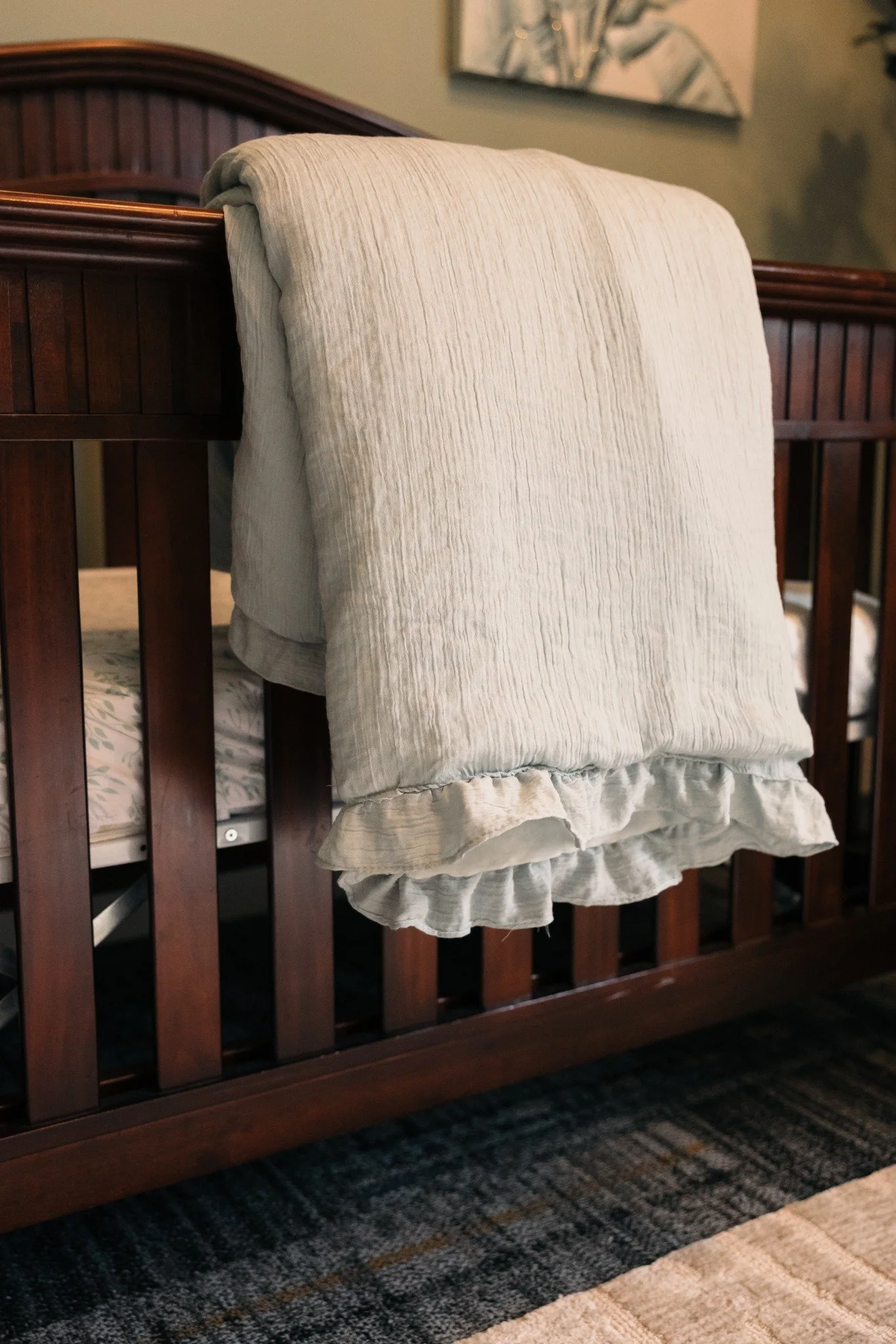 Soft blanket draped over a crib in the Ramble Creek nursery for couples planning kid-friendly weddings in Tennessee.