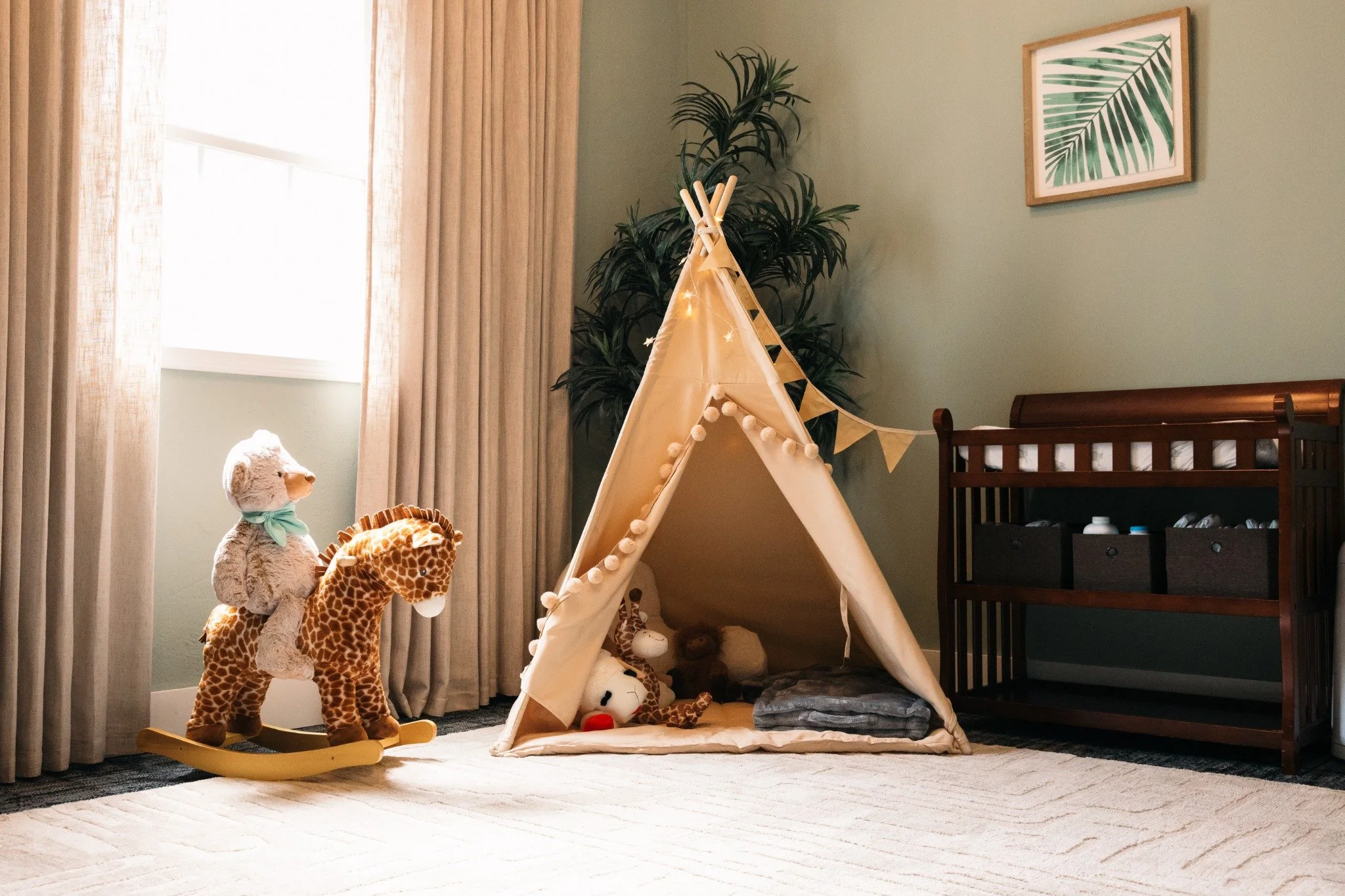 Kids playroom at Ramble Creek with a teepee, rocking giraffe, crib, and soft rug for family-friendly wedding celebrations.