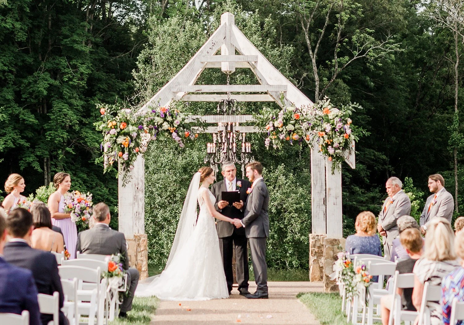 Wedding officiant leading an outdoor ceremony for a bride and groom at Ramble Creek Events, Athens, Tennessee