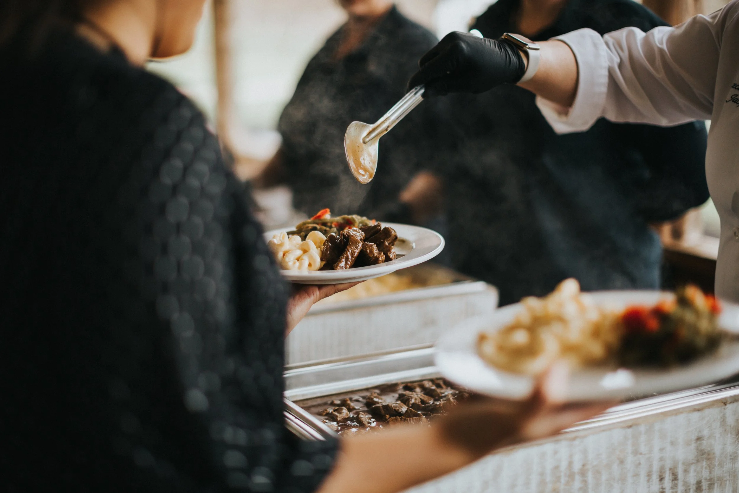Ramble Creek wedding staff serving wedding dinner buffet, cooked on-site by full time executive chef. 