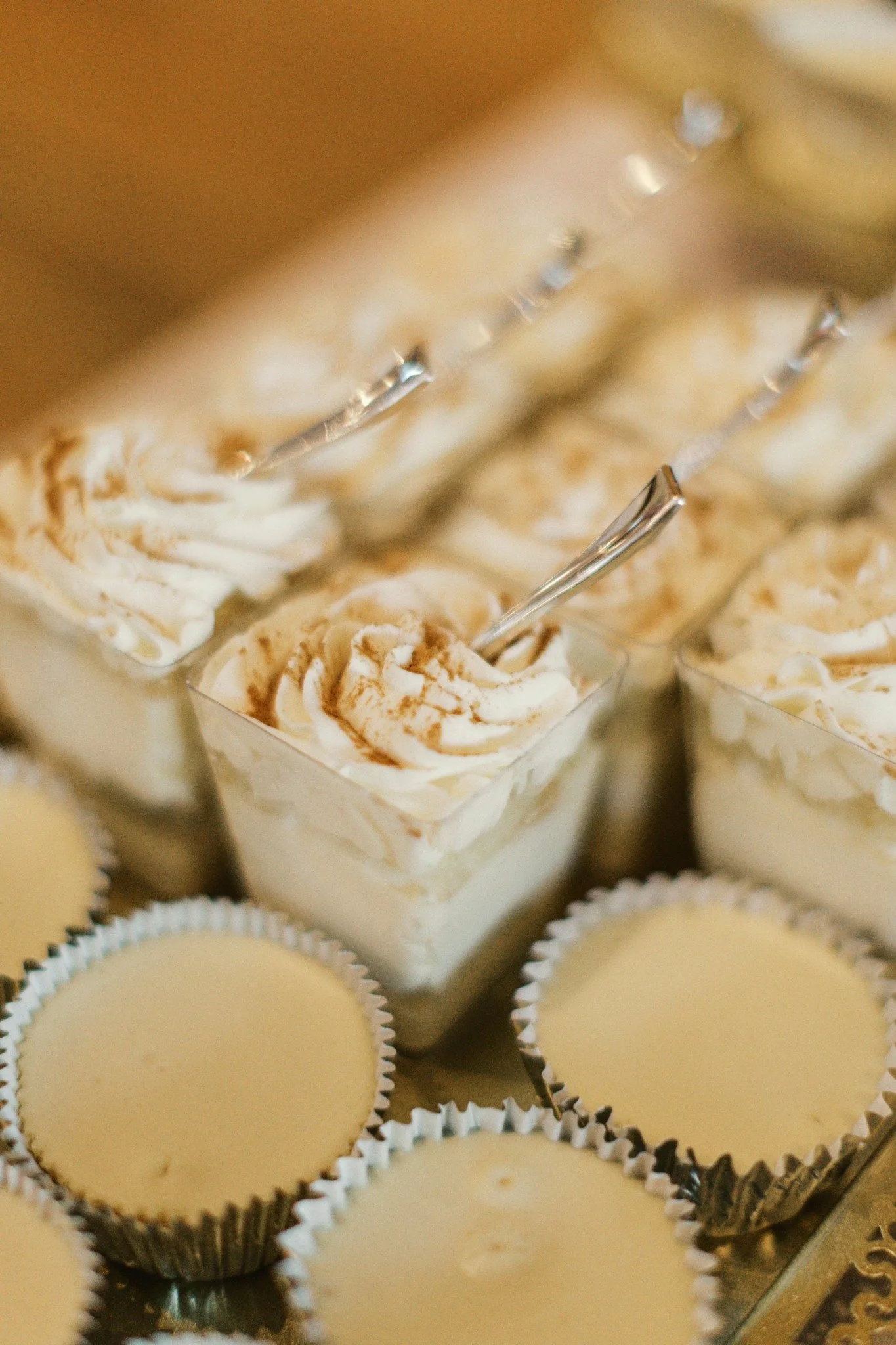 Close-up of mini dessert cups and cheesecakes served at a Ramble Creek wedding reception dessert table.