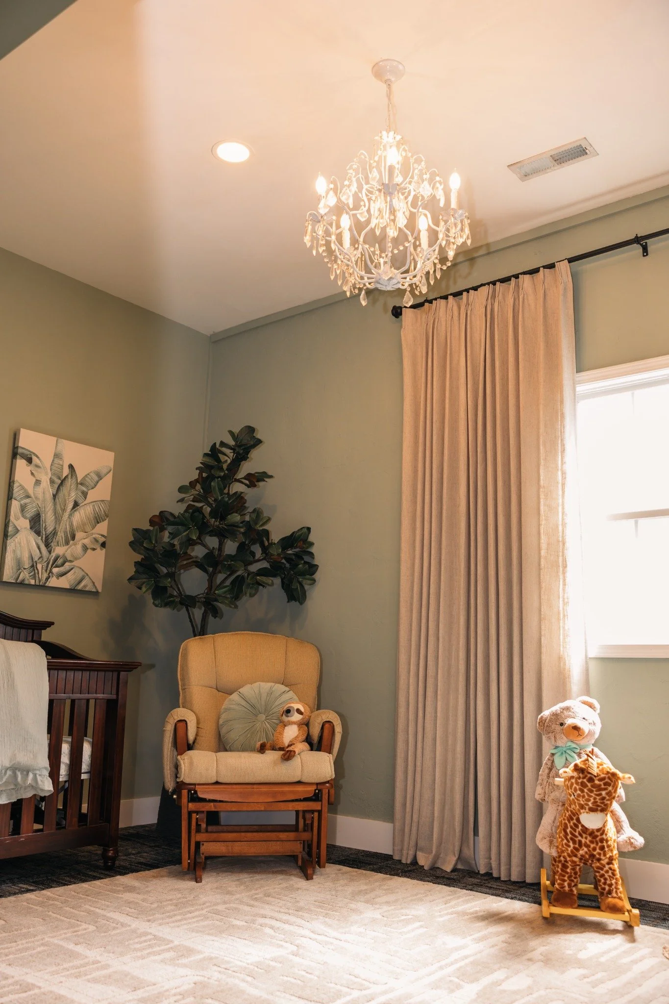 Ramble Creek nursery with crib, rocking chair, chandelier, and toys for kid-friendly weddings at a Tennessee wedding venue.