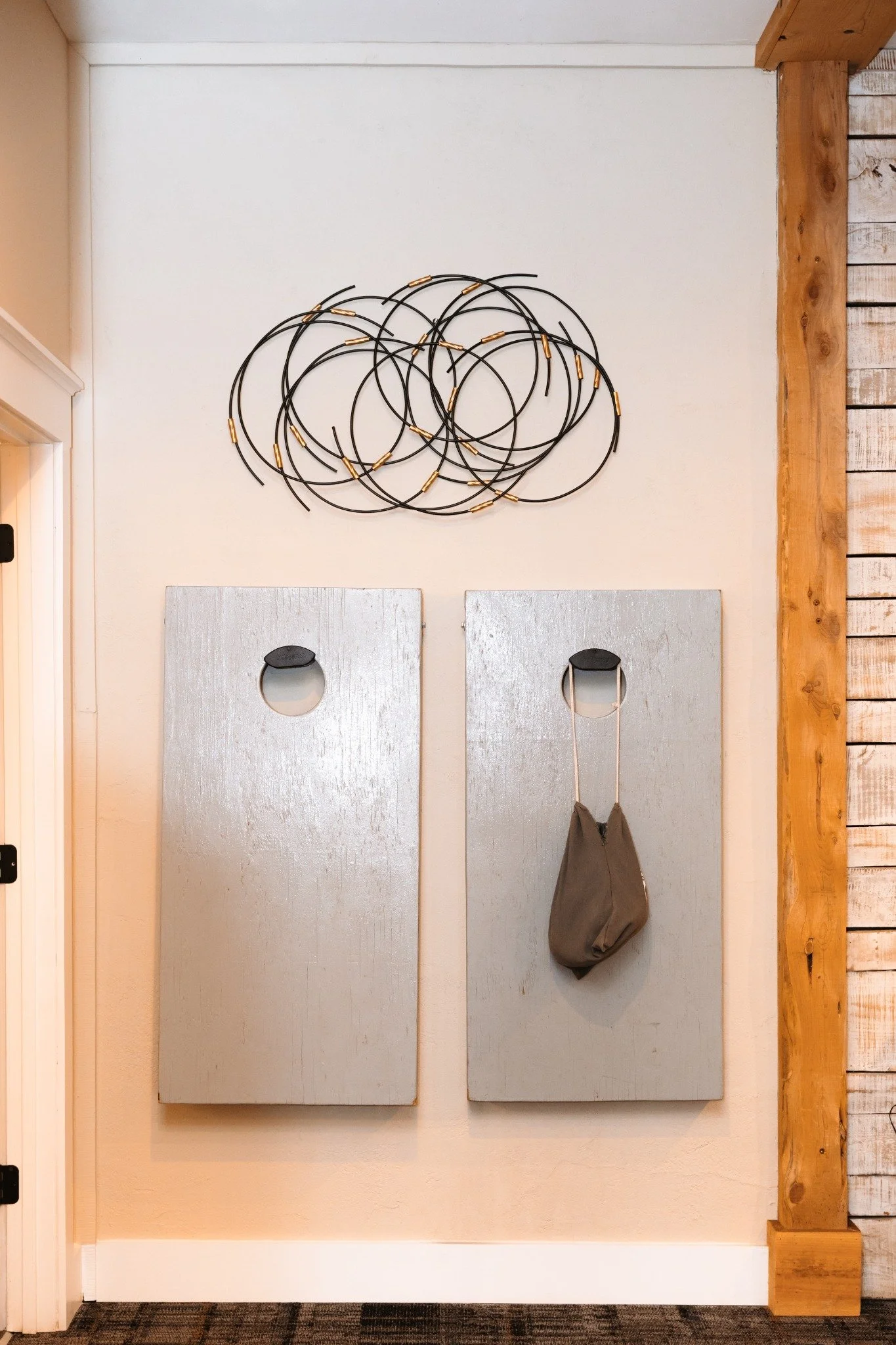 ramble-creek-grooms-quarters-cornhole-storage-wall.jpg