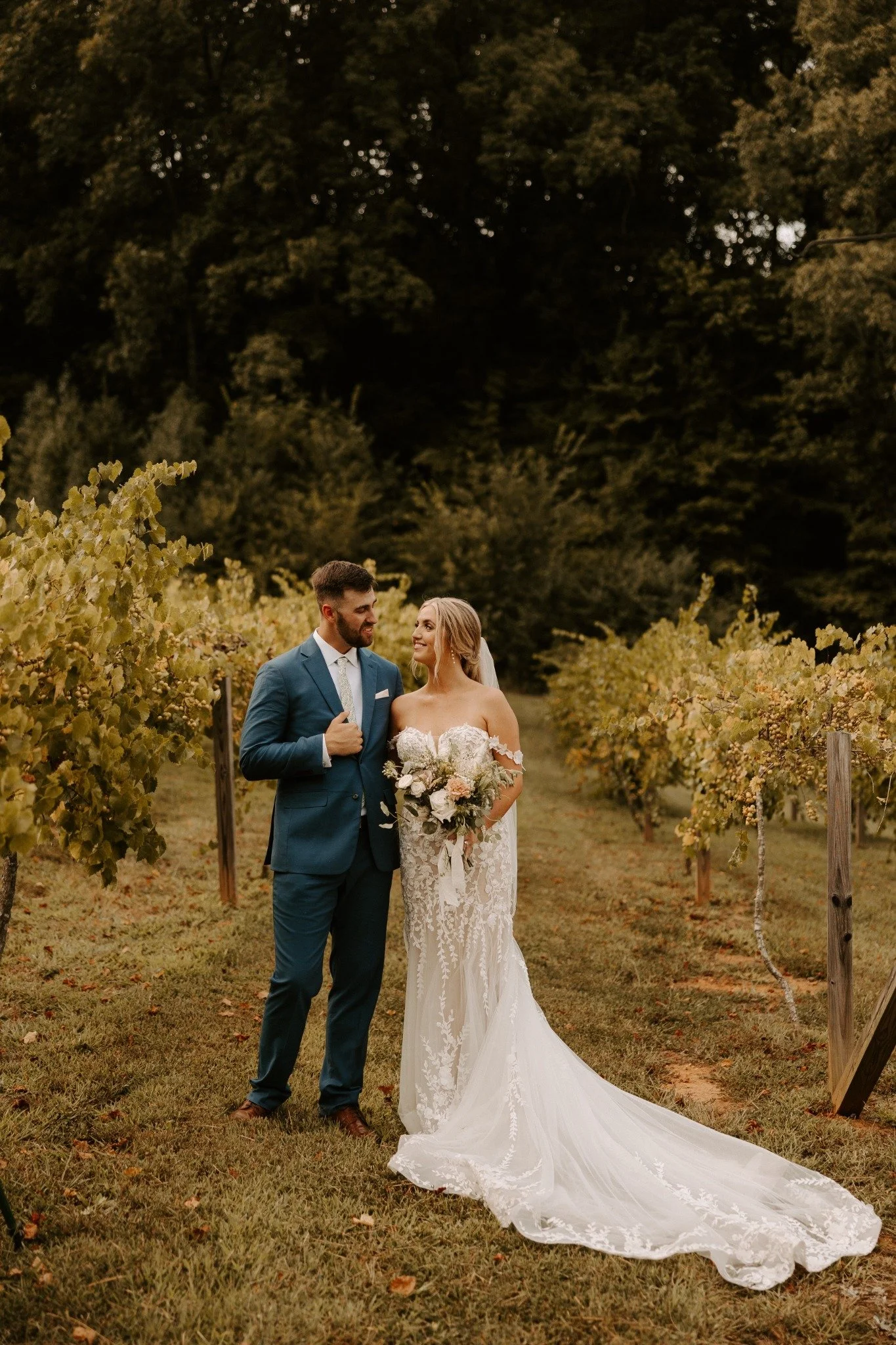 Bride and groom share a quiet wedding portrait among the vineyard rows at Ramble Creek, an all-inclusive wedding venue in Athens, Tennessee