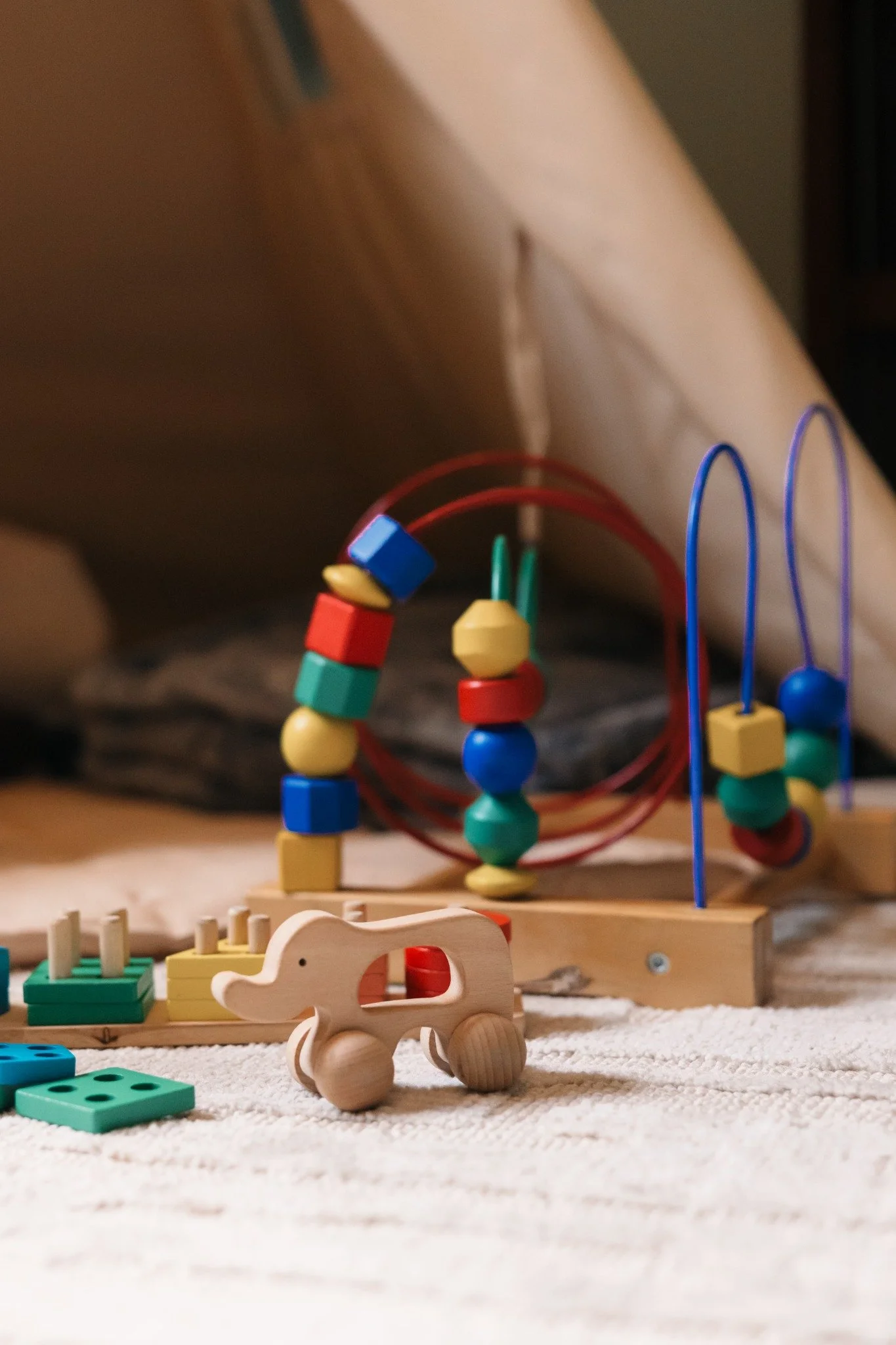 Wooden toys and bead maze in the Ramble Creek nursery children’s play area for family-friendly wedding celebrations.