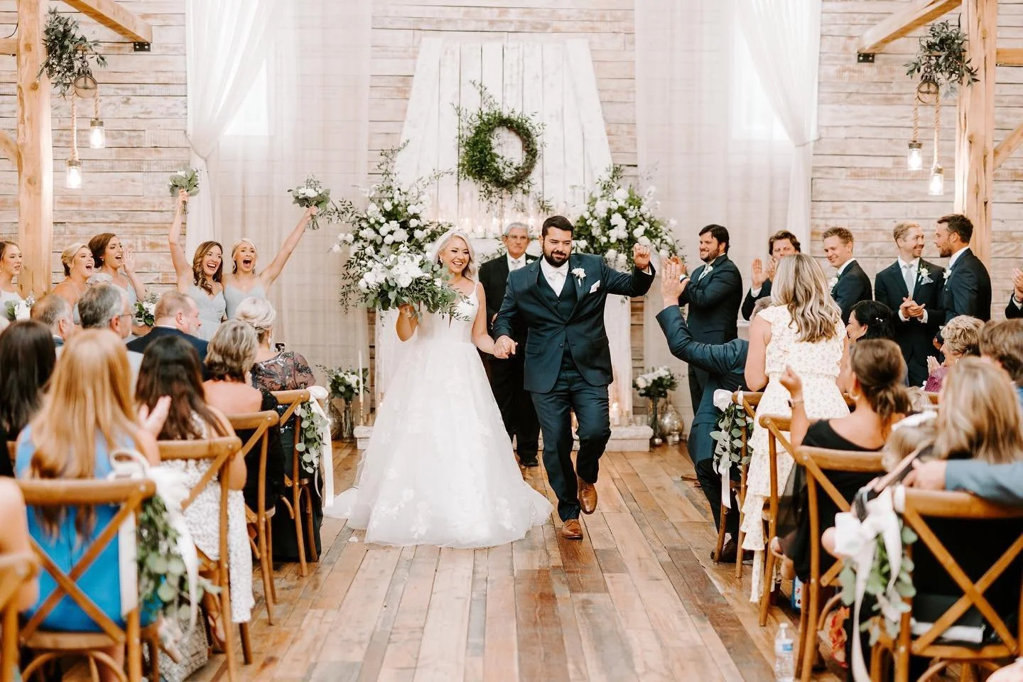Newlyweds walking down the aisle after indoor ceremony in the Grand Hall at Ramble Creek Tennessee wedding venue