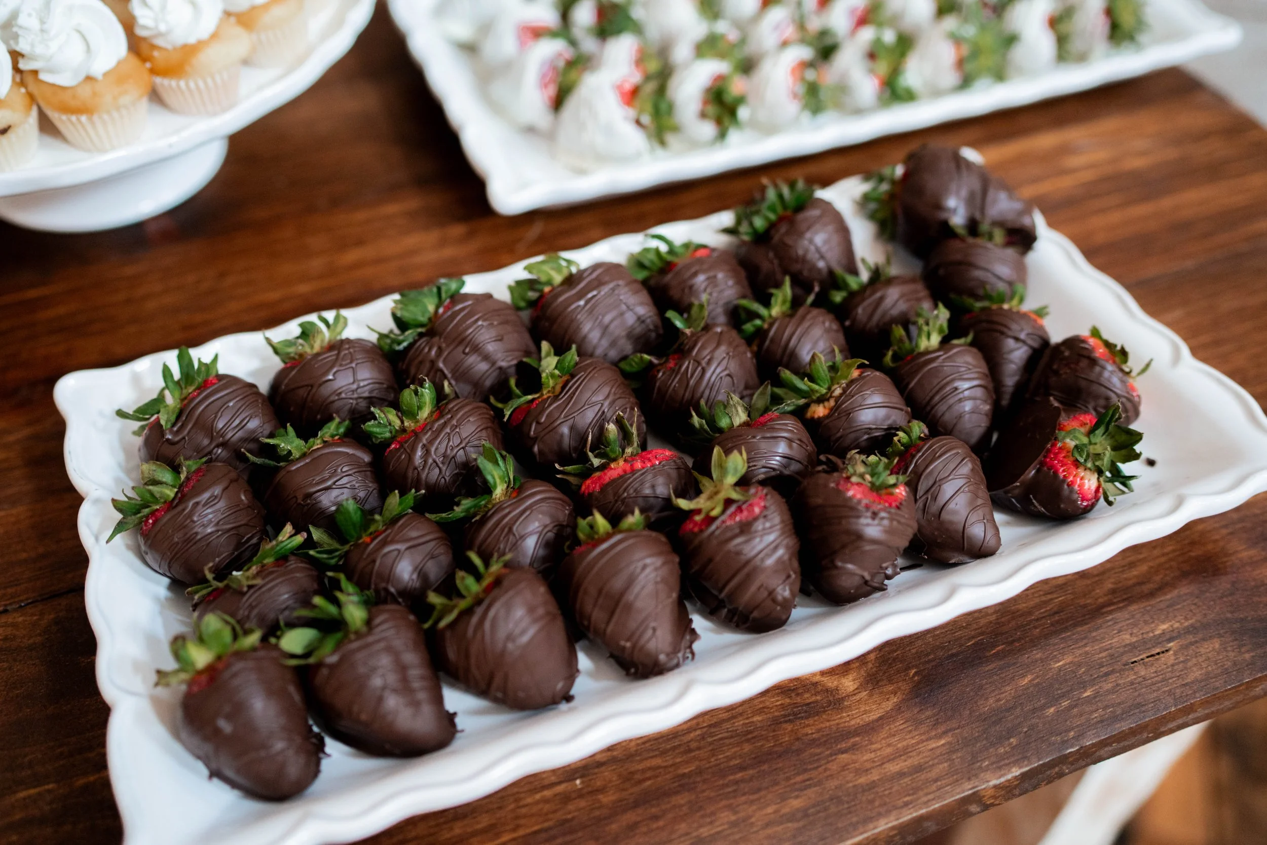 Chocolate-covered strawberries on a white platter, to be served at wedding reception in Tennessee.