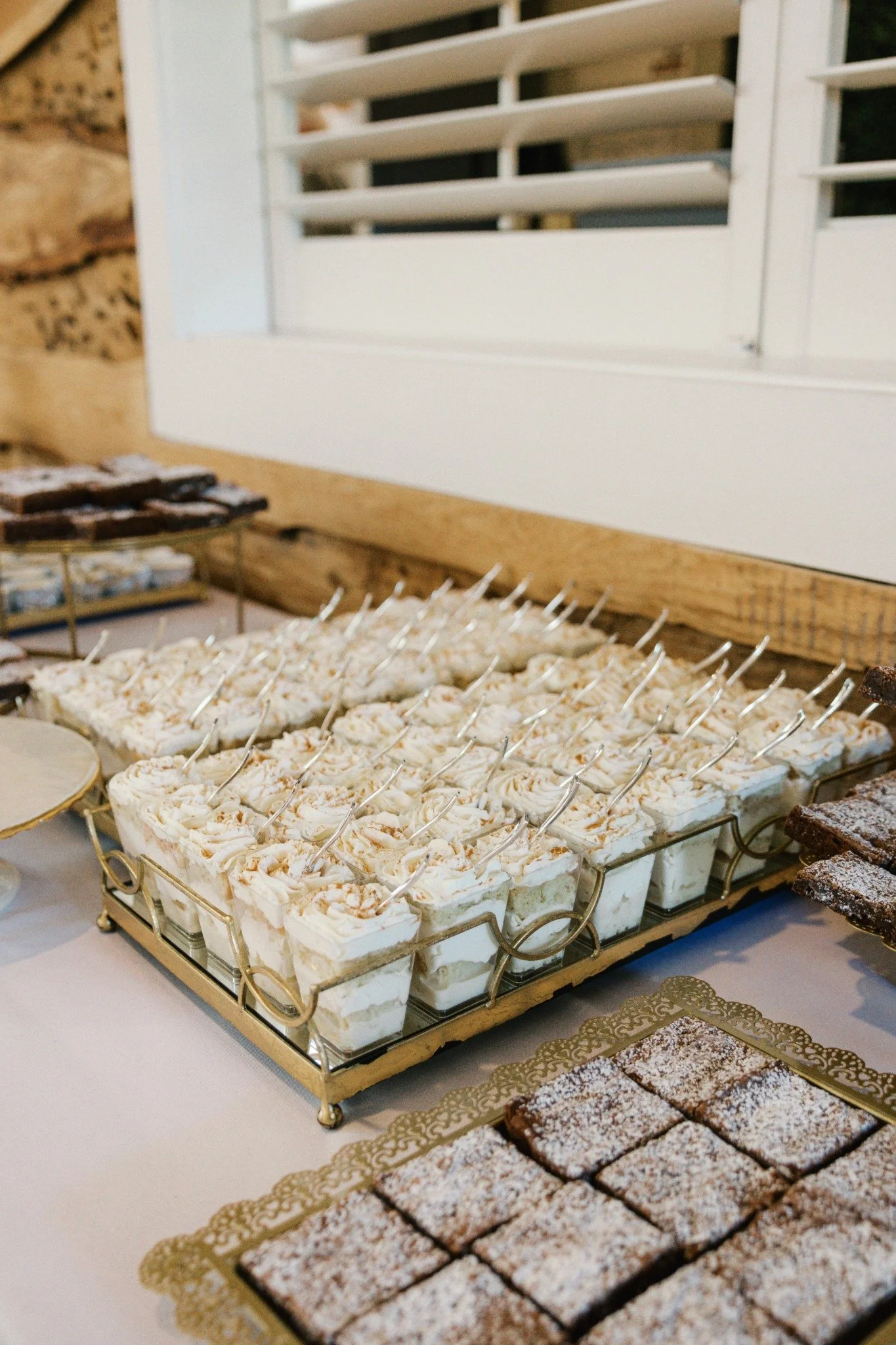 Wedding dessert bar at Ramble Creek featuring parfait cups, brownies, and assorted sweets for reception guests