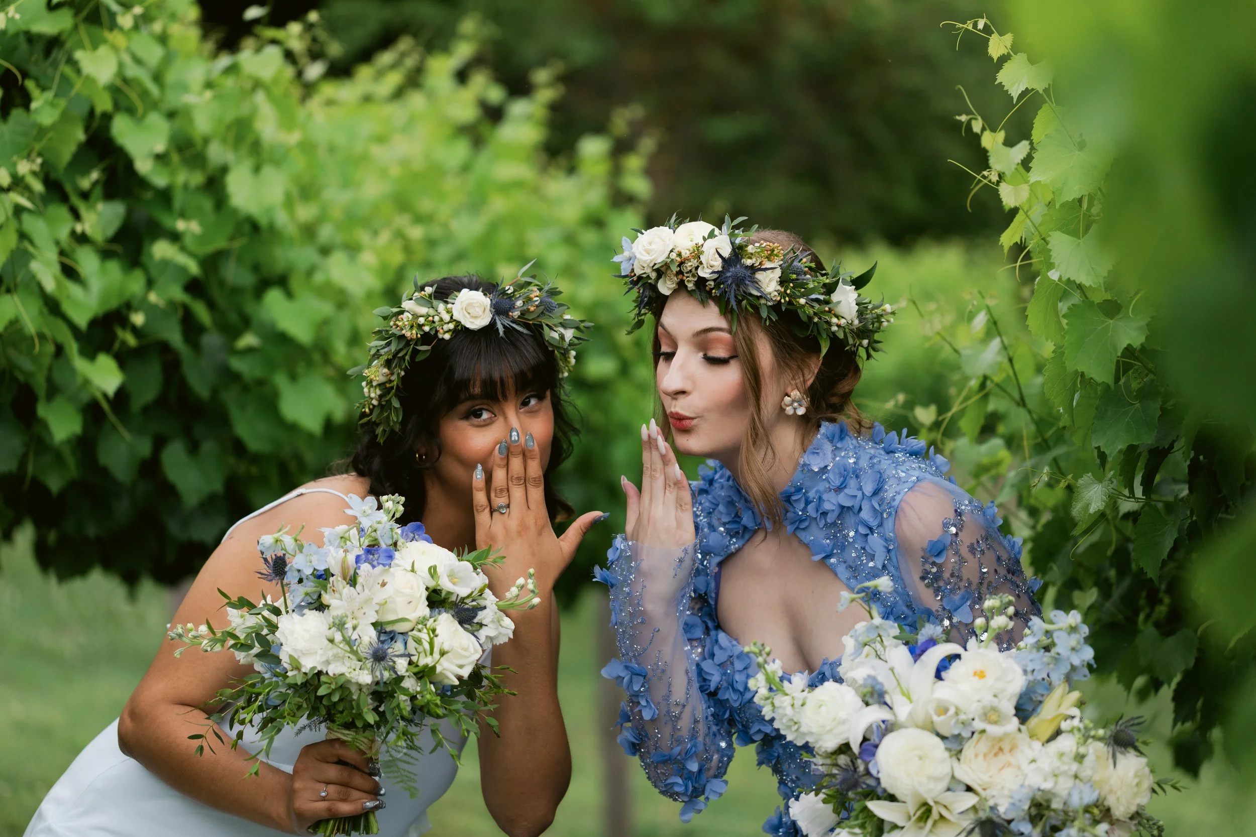 Bride in a blue floral wedding dress and bridesmaid wearing floral crowns at Ramble Creek, an all-inclusive East Tennessee wedding venue in Athens TN.