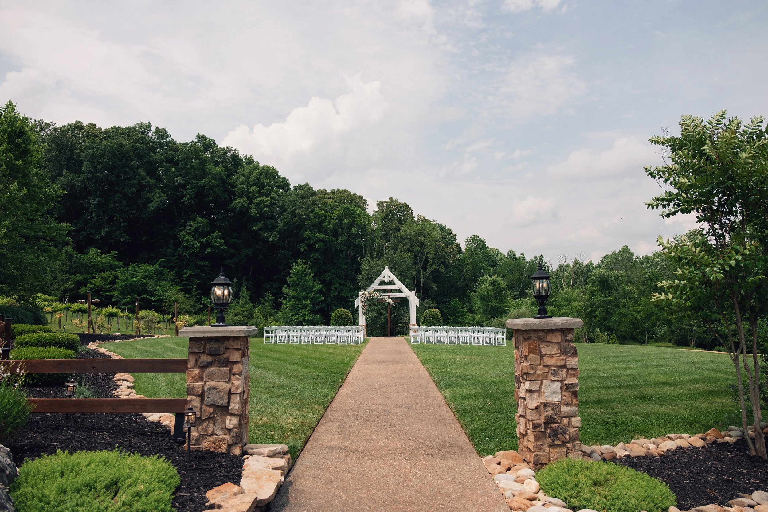 upper-lawn-outdoor-ceremony-white-arbor-may-wedding.jpg