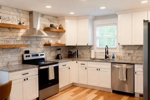 Kitchen inside the Villa at Ramble Creek, featuring white cabinetry, stainless steel appliances, marble-style backsplash, open shelving, and warm wood floors.