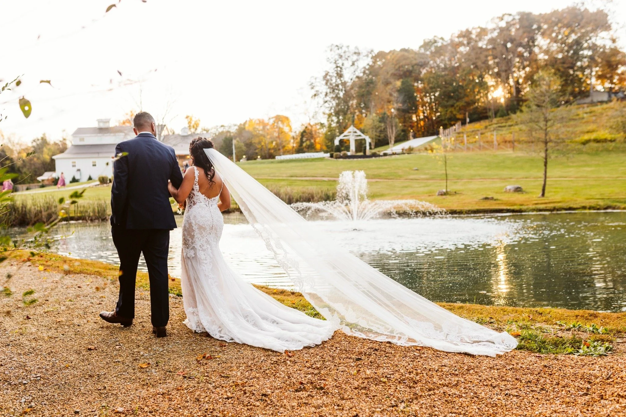 ramble-creek-fall-wedding-pond-fountain-newlyweds.jpeg