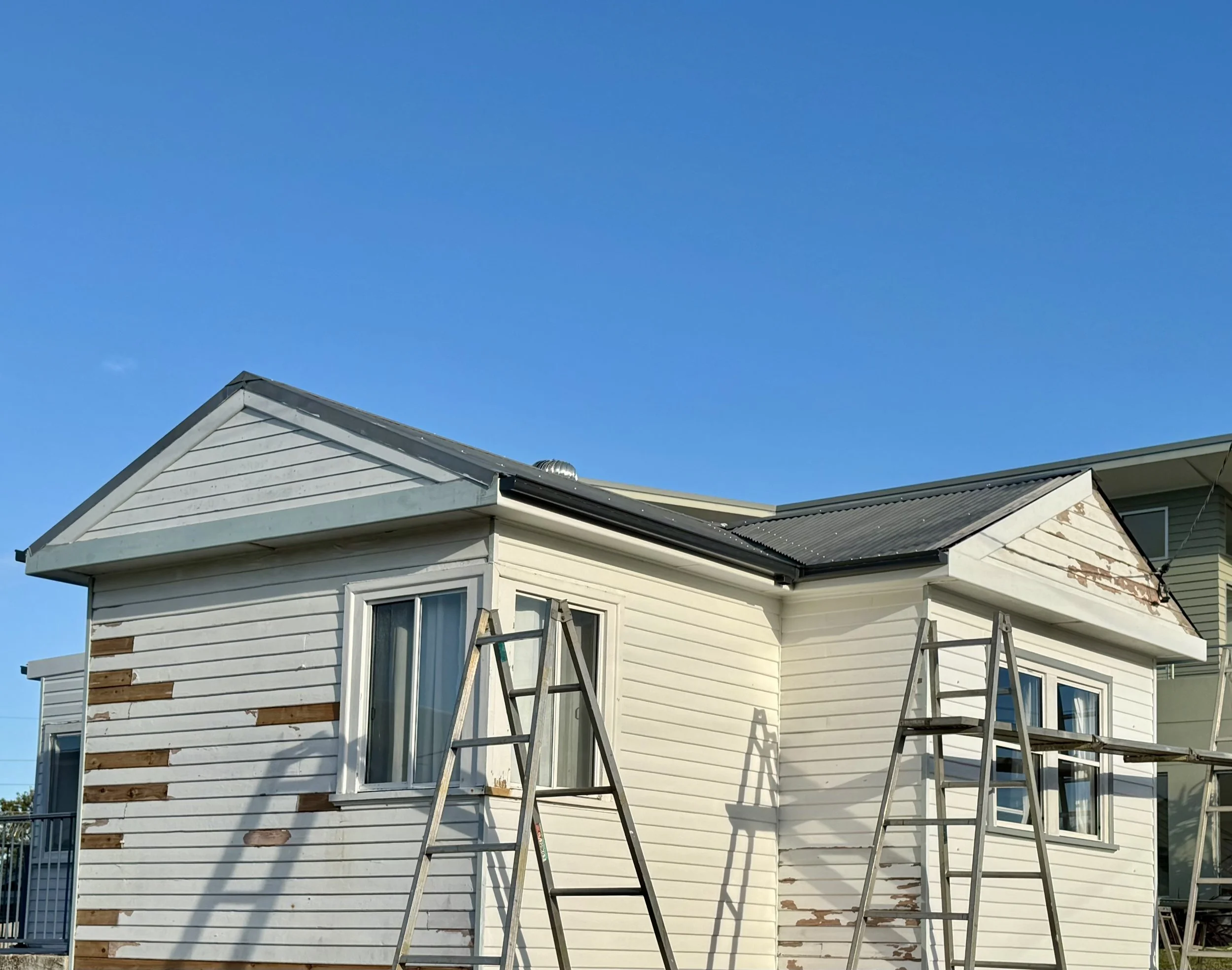 Exterior home requiring painting and maintenance repairs.