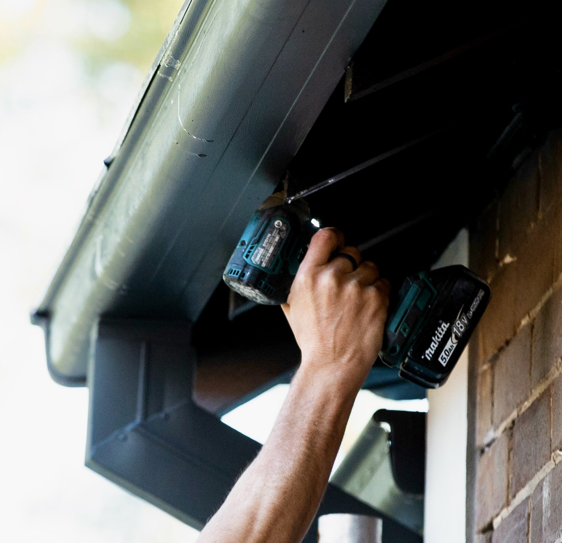 Property maintenance repair using a cordless drill.