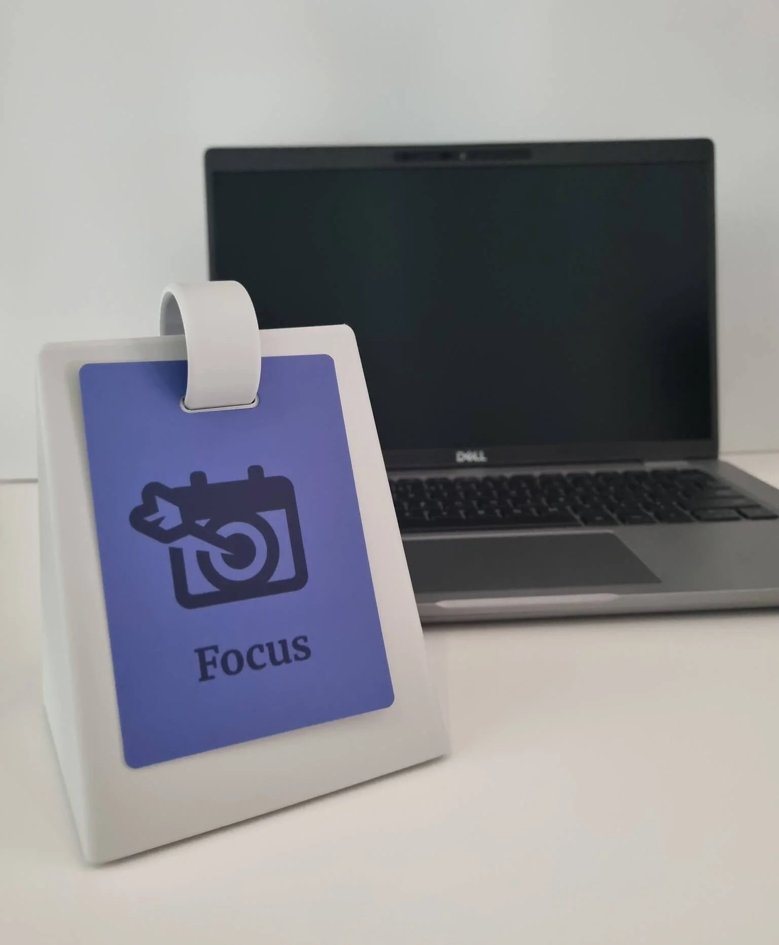 SocialFlip Focus card on a desk beside a laptop.