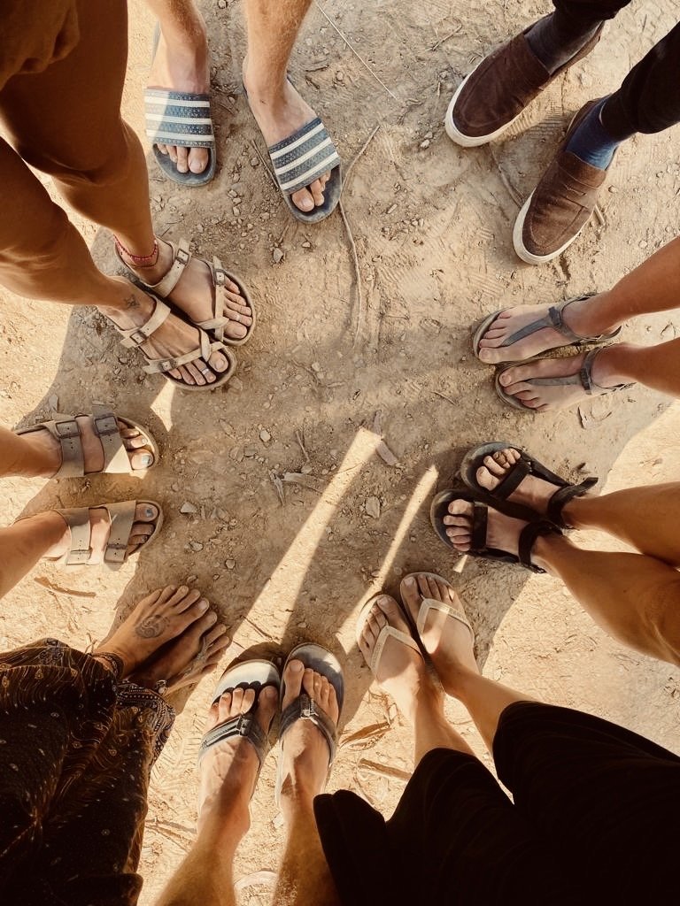 group of travel friends dirty feet after an adventure