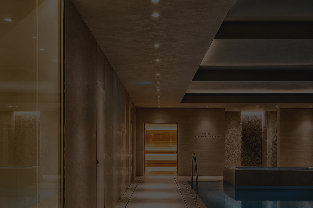Indoor spa area with pool, wooden walls, and lighting.