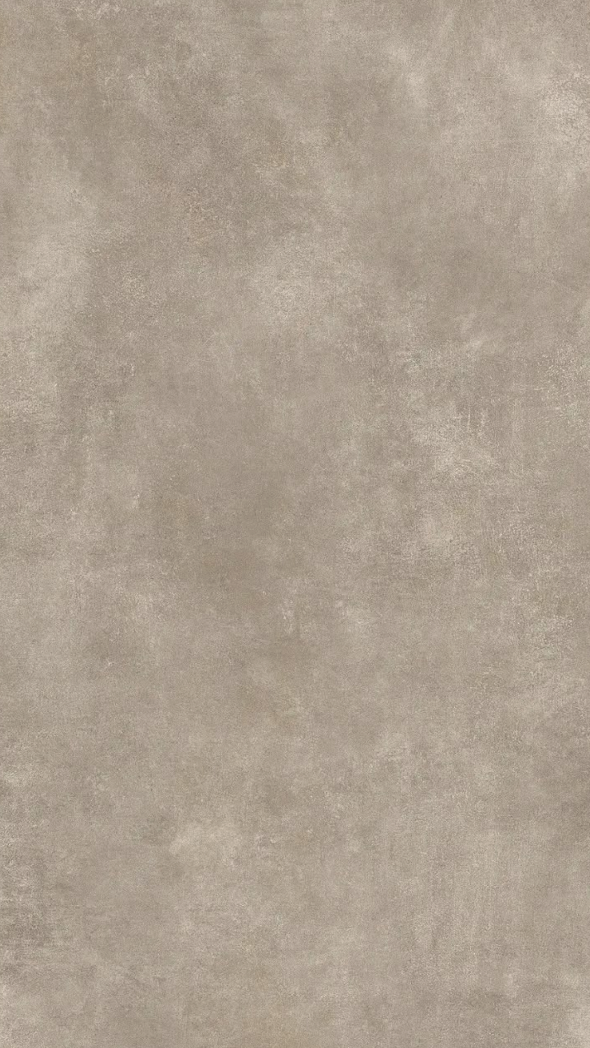 A plain, beige, textured surface, possibly a tile or stone wall.