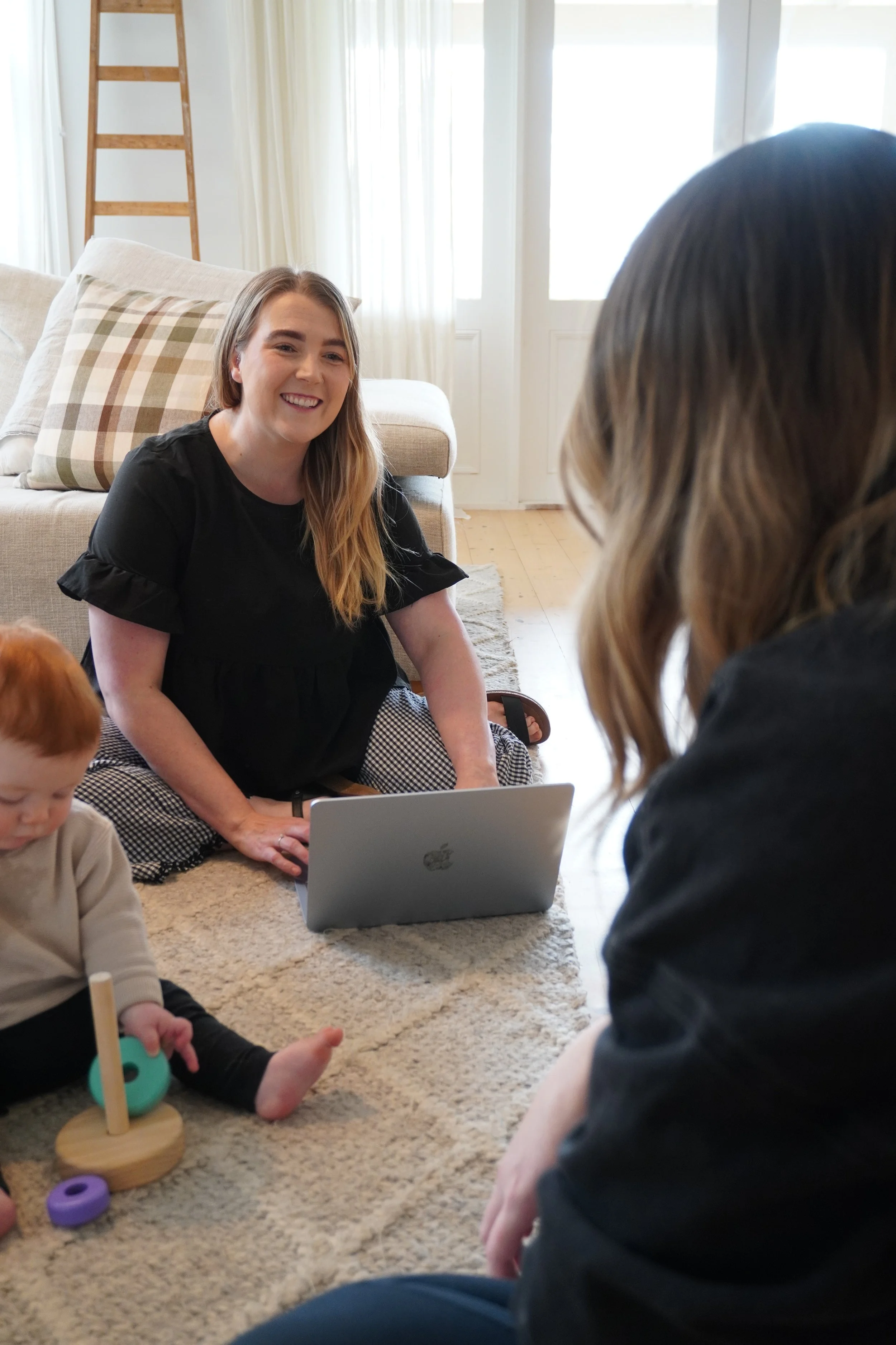 Perinatal psychologist with mum and infant in a session