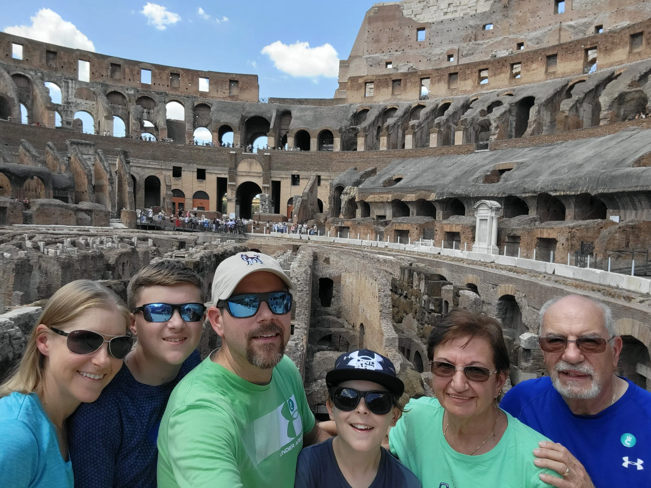 Group family from grandparents to kids in the Colosseum in Rome, Italy