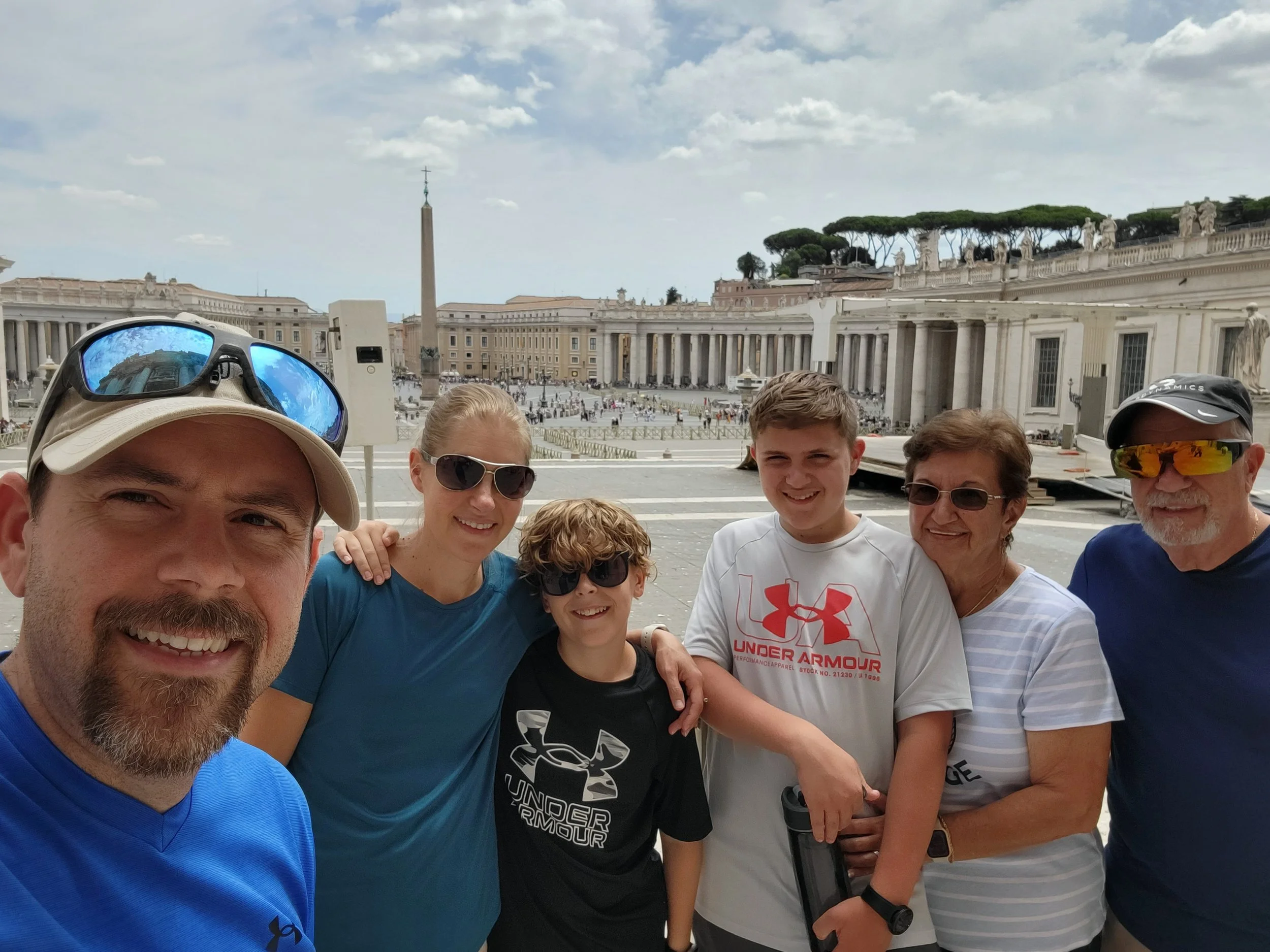 Three generations standing in St. Peter's Square in Vatican City.