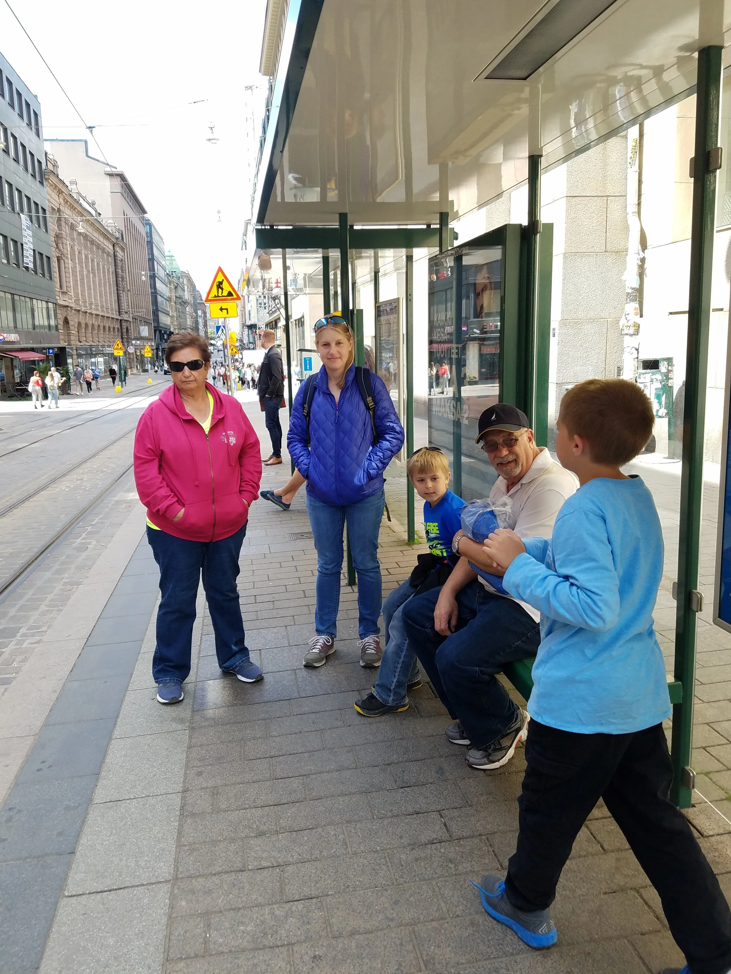 Family waiting at a tram stop in Helsinki, Finland