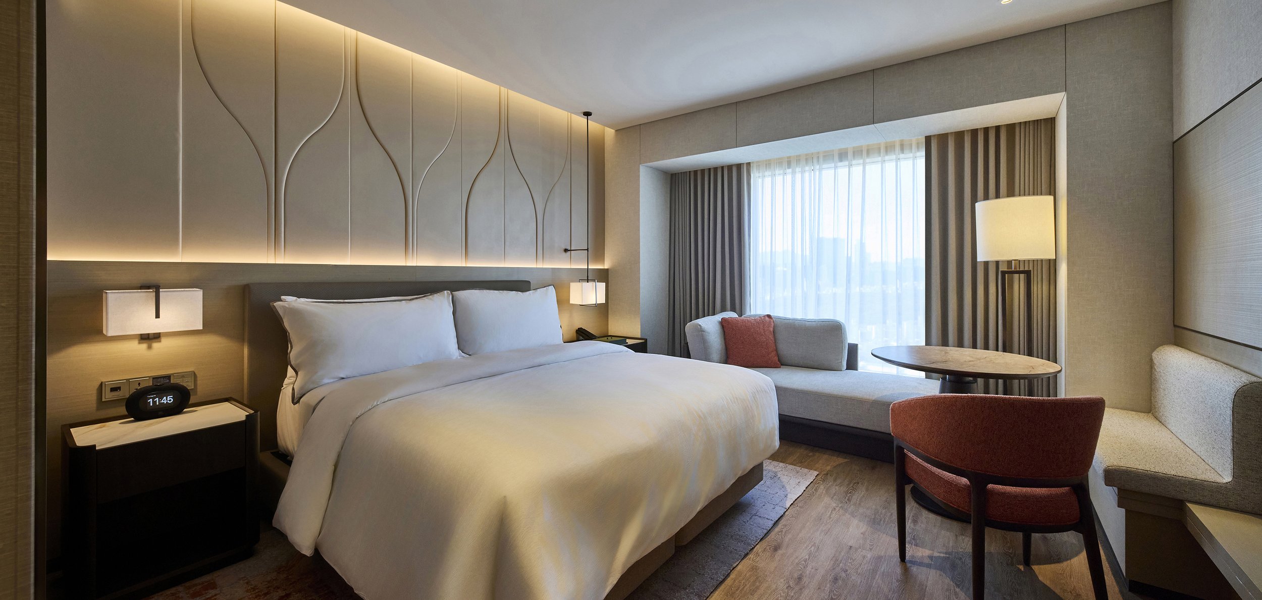 luxury-hotel-guestroom-king-bedroom-ambient-beige-tulip-headboard-01.jpg