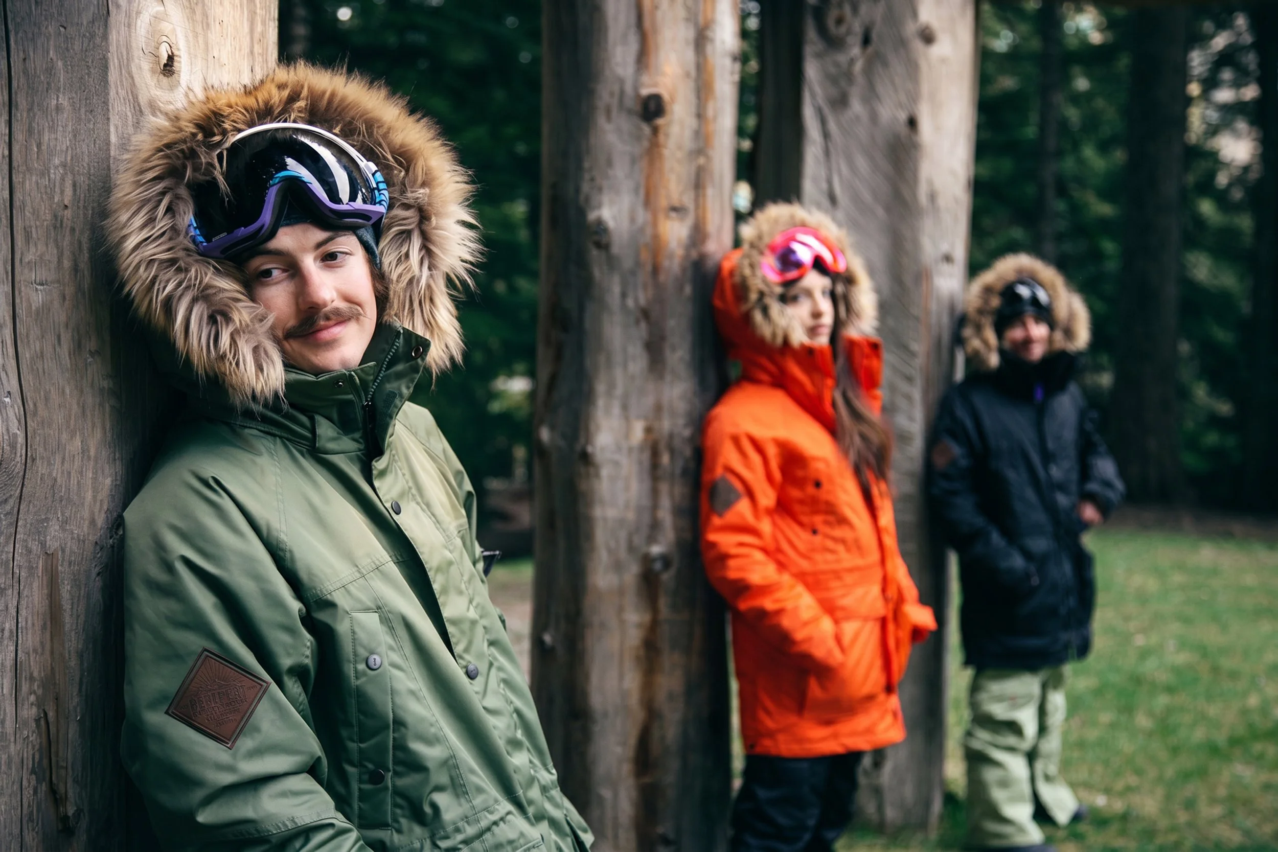 snowboard-parka-lifestyle-group-olive-orange-black-log-wall-07.jpg