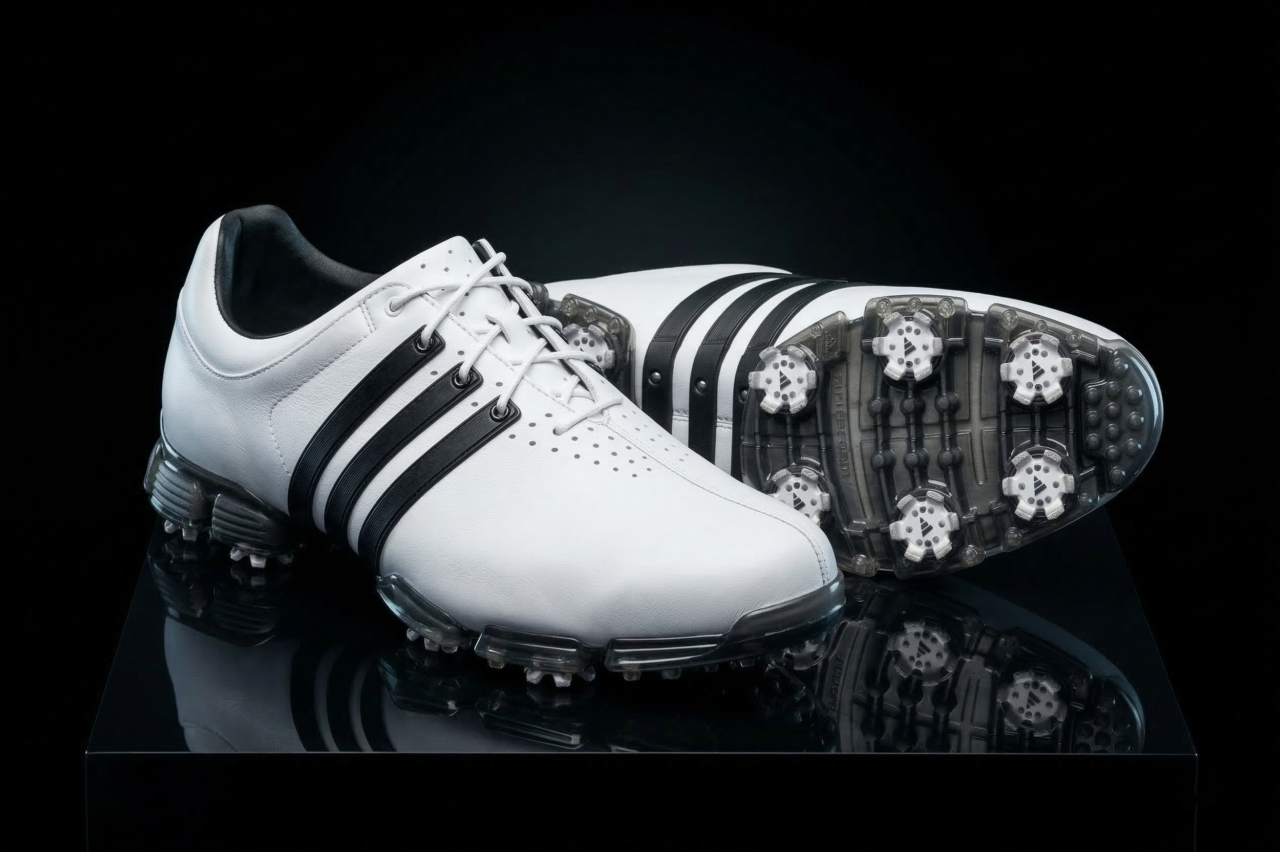 adidas-golf-shoe-3stripe-white-black-pair-sole-detail-black-bg-01.png