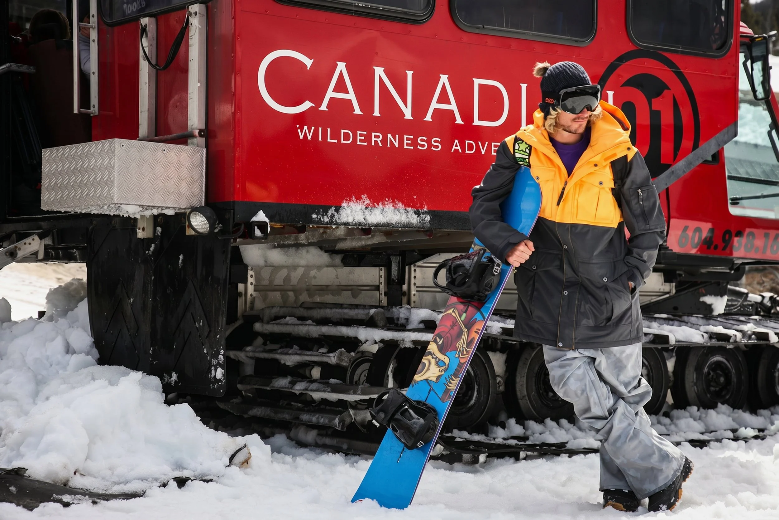 snowboard-jacket-lifestyle-male-yellow-gray-snowboard-canadian-wilderness-01.jpg