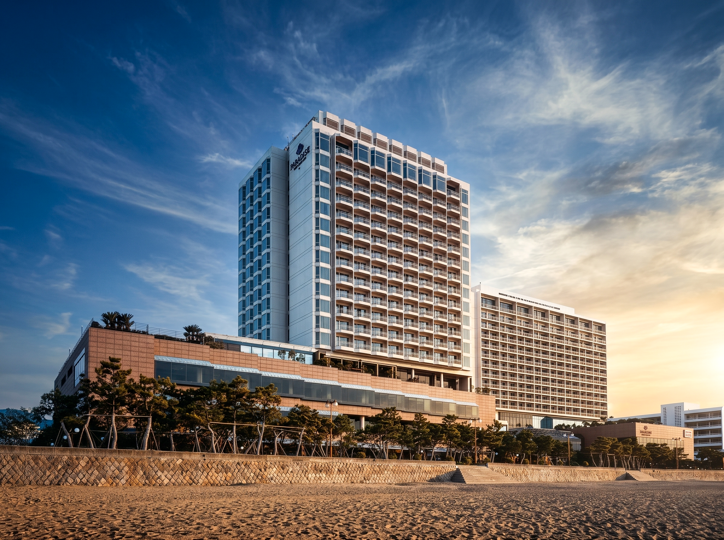 paradise-hotel-busan-exterior-front-beach-golden-hour-daytime-01.png