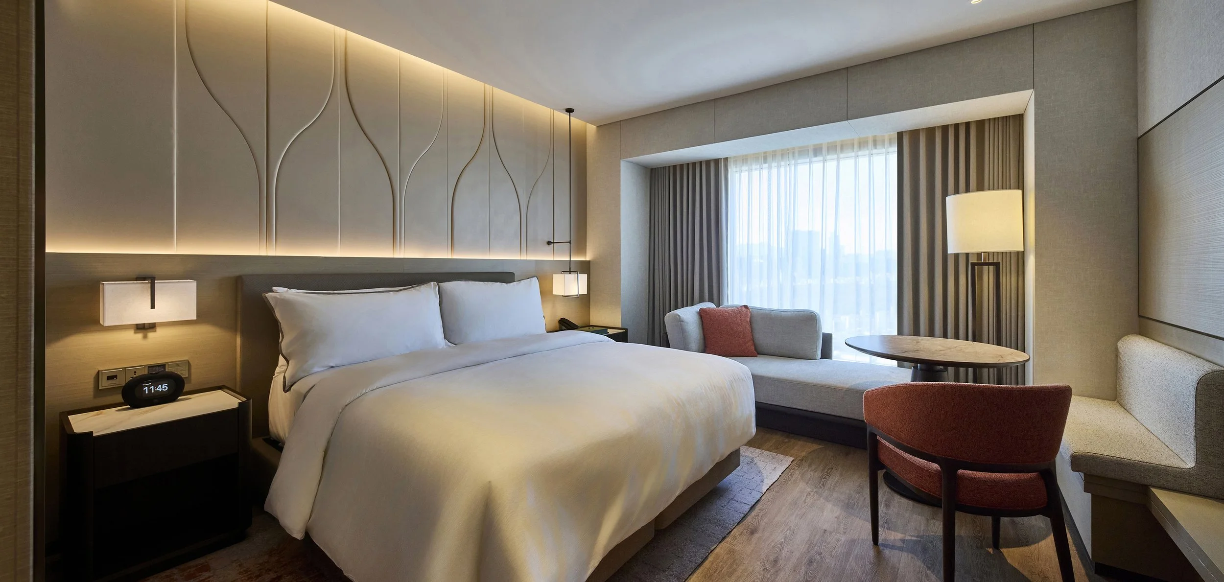 luxury-hotel-guestroom-king-bedroom-ambient-beige-tulip-headboard-01.jpg