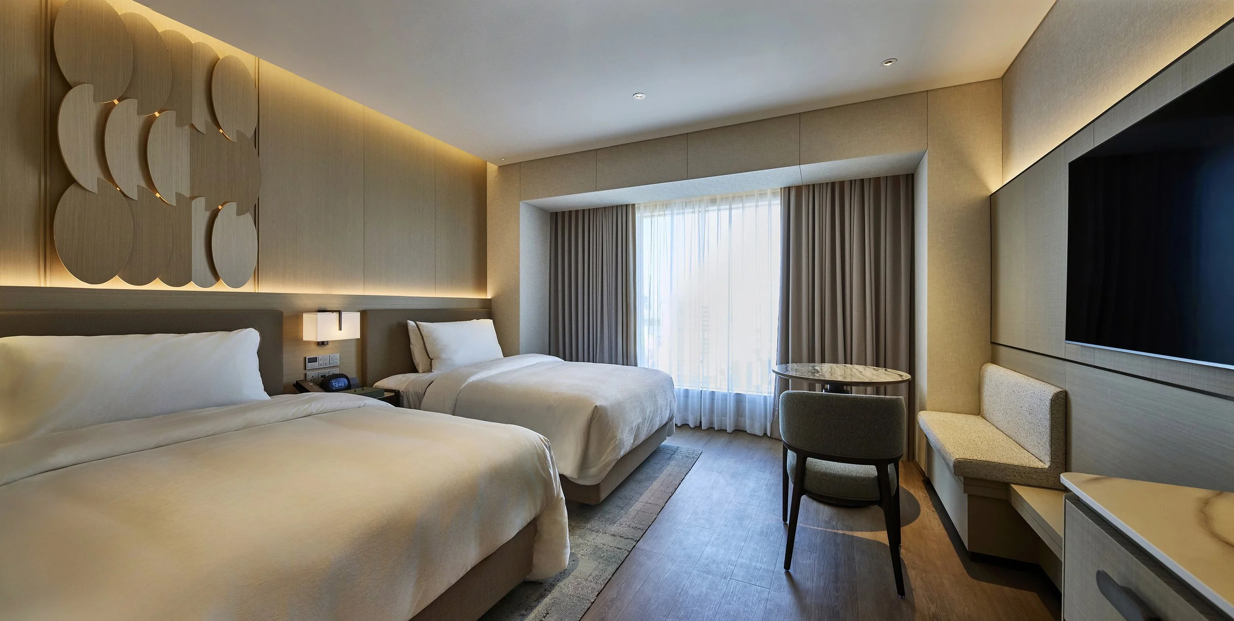 luxury-hotel-guestroom-twin-bedroom-ambient-beige-circle-headboard-04.jpg