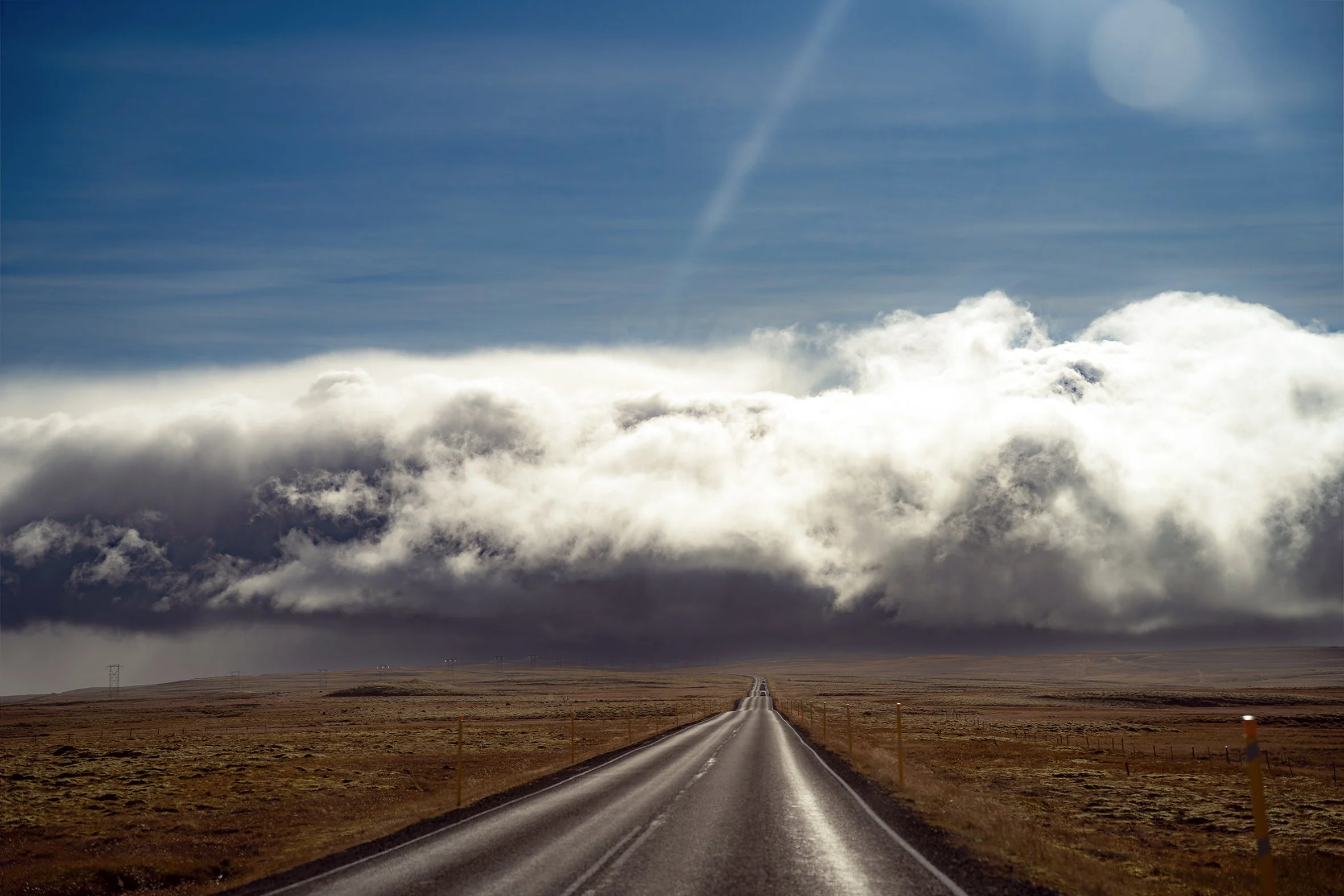 Long road disappearing into storm clouds during the drive back to Reykjavik, Iceland