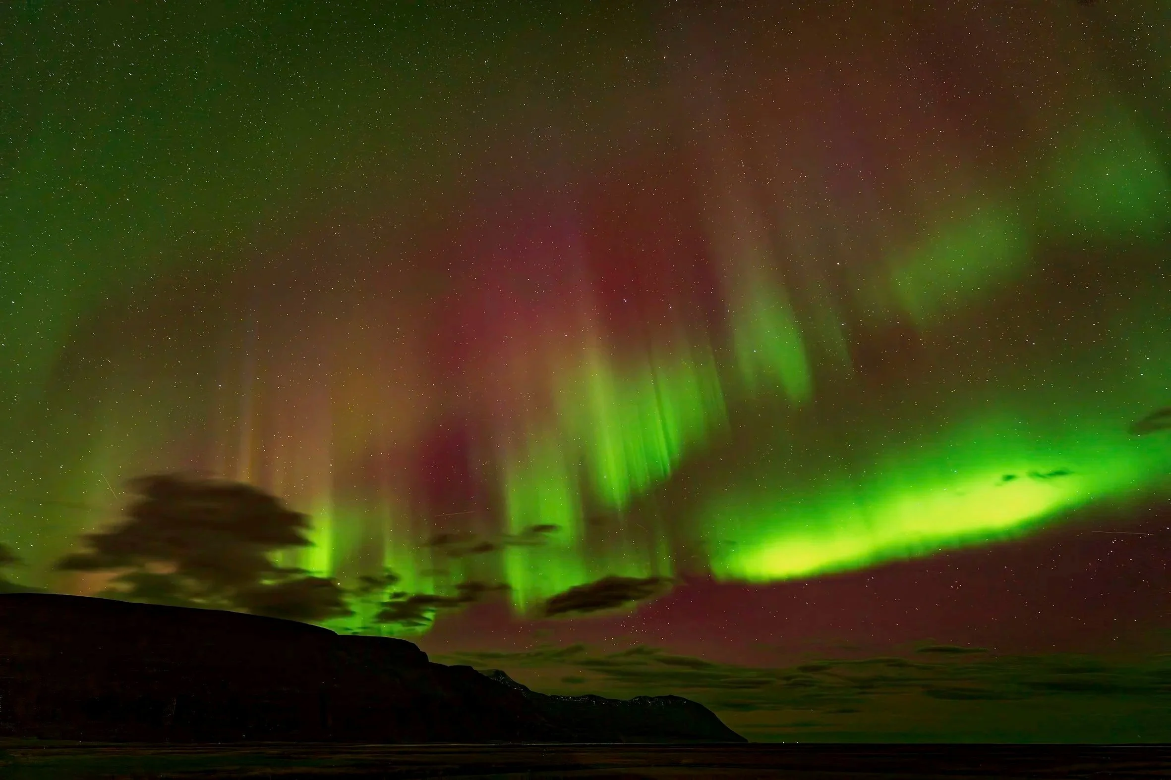Northern lights above the landscape near Húsavík, Iceland