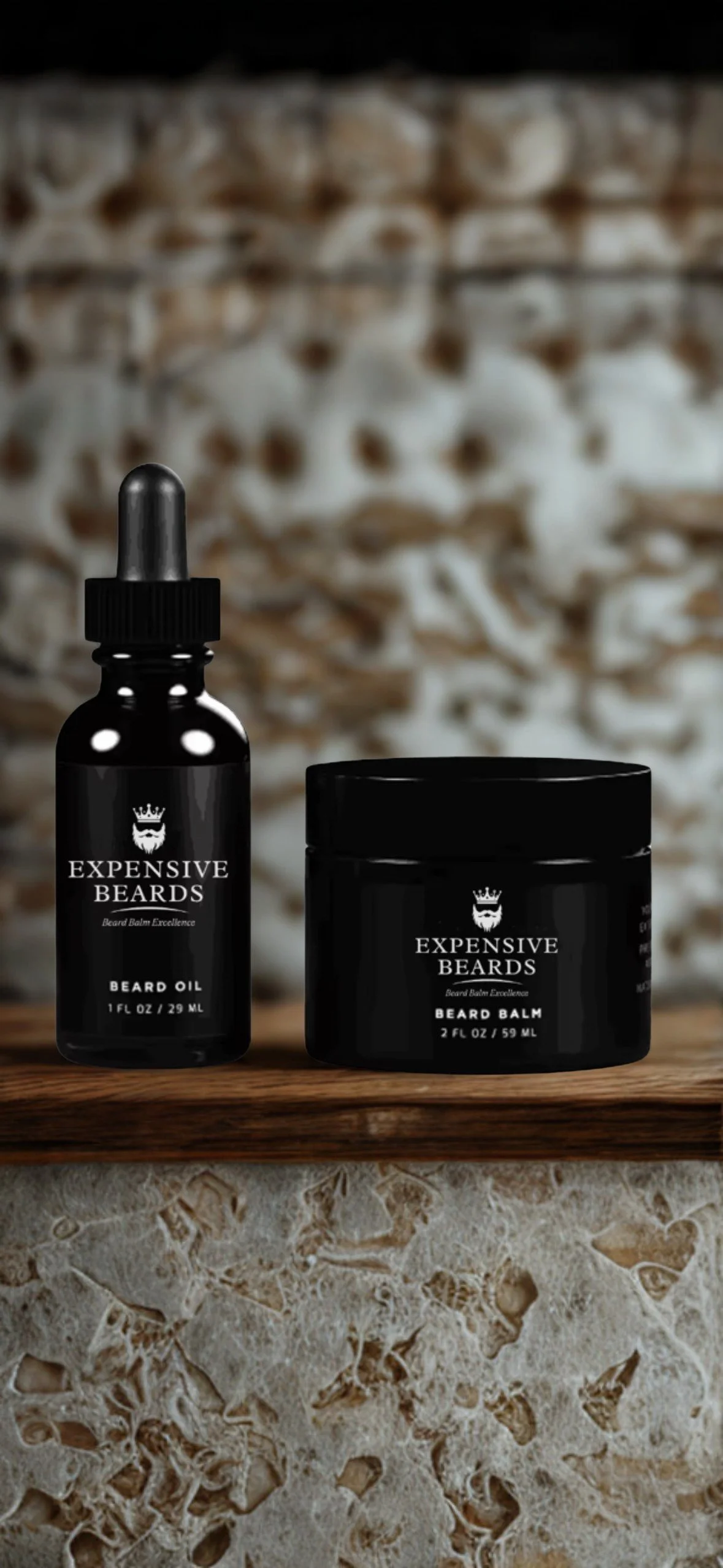 Black bottles labeled 'Expensive Beards' containing beard oil and beard balm are placed on a wooden surface. Background features a rustic brick wall.