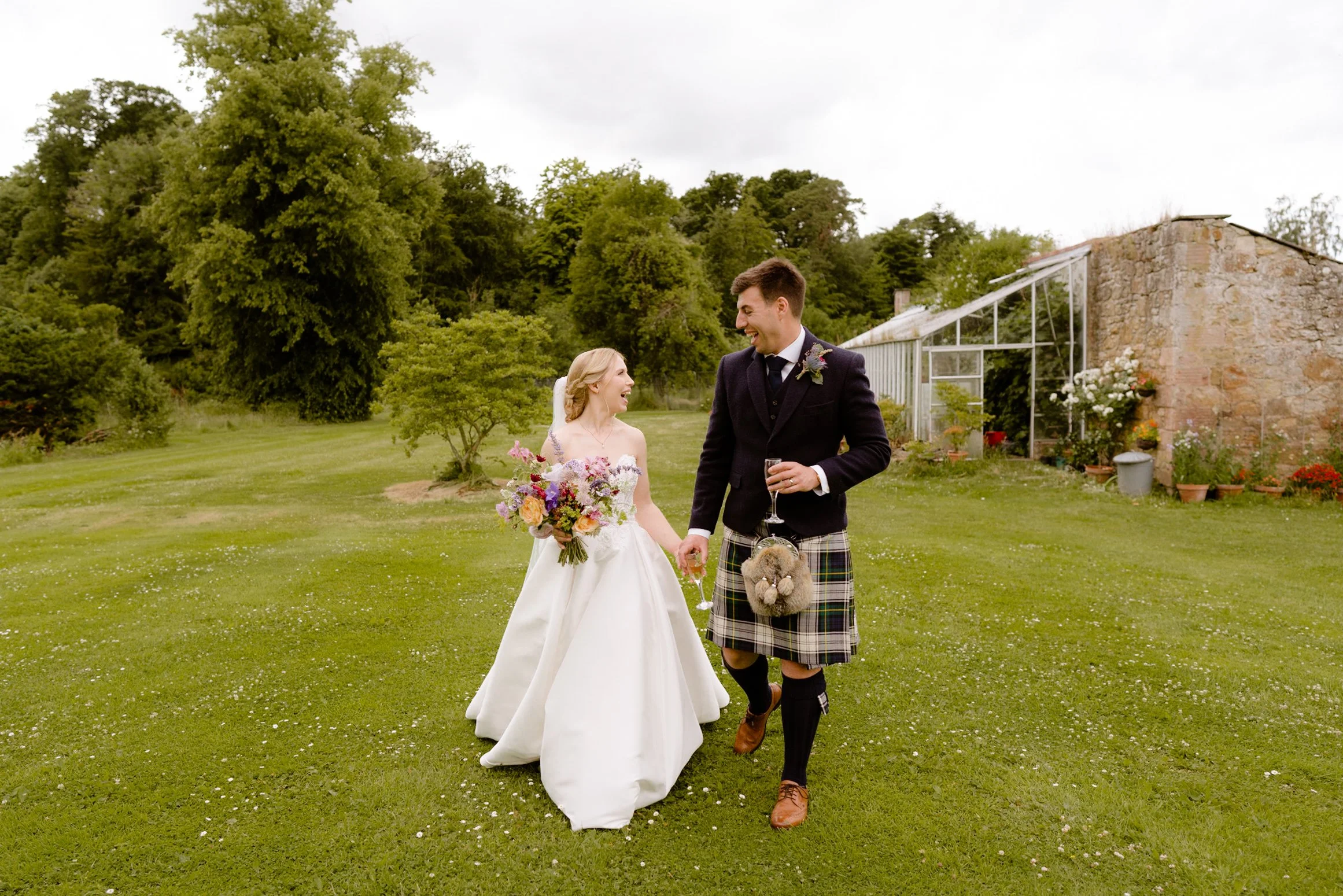 beautiful couple walking together after getting married on a beautiful estate by ottawa wedding photographer christine mcnally