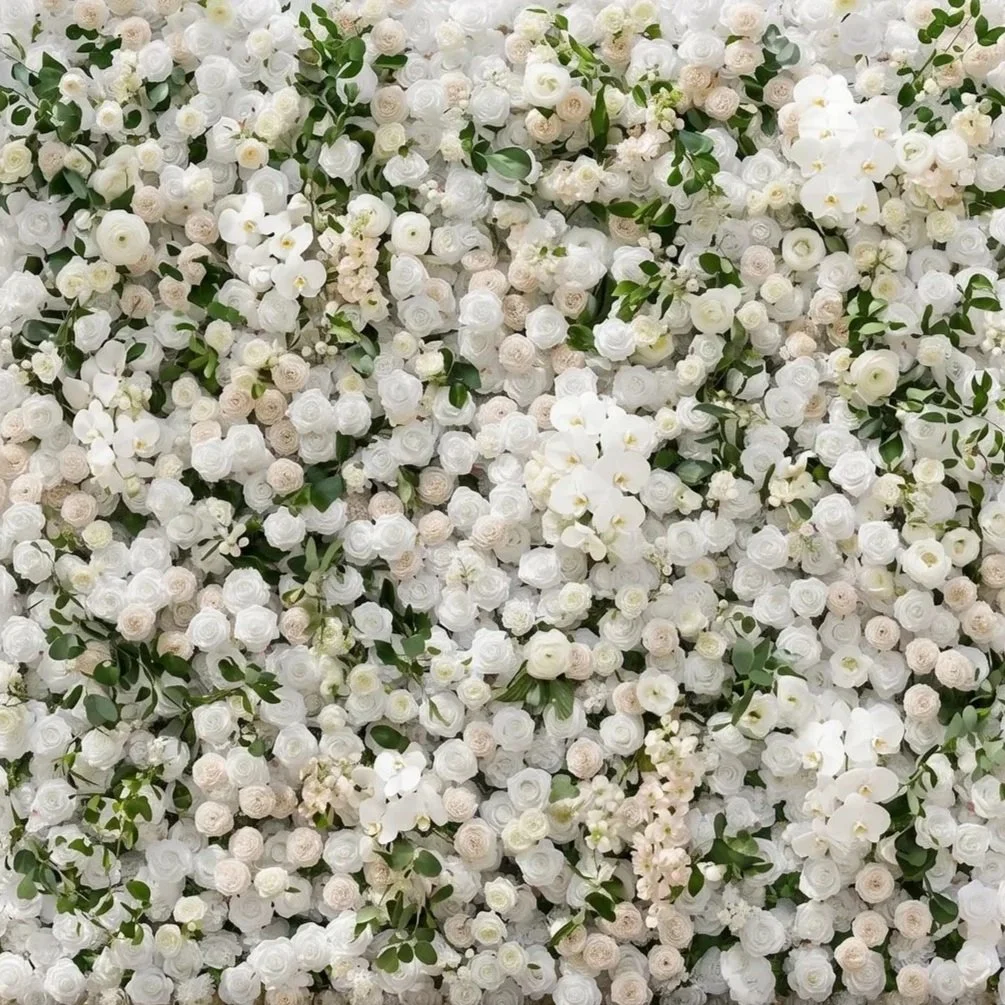 A dense wall of white and cream-colored roses and orchids with green foliage interspersed.